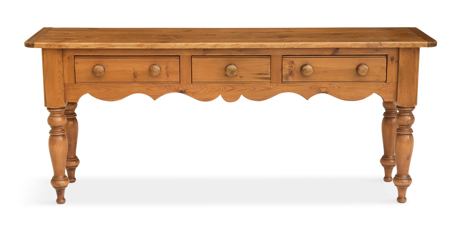 English Scrubbed Pine Buffet: English Scrubbed Pine Buffet 20th century, the plank top with breadboard ends, over three side-by-side drawers and a scalloped apron below, raised on turned legs. h. 30-1/2", w. 72", d. 19"