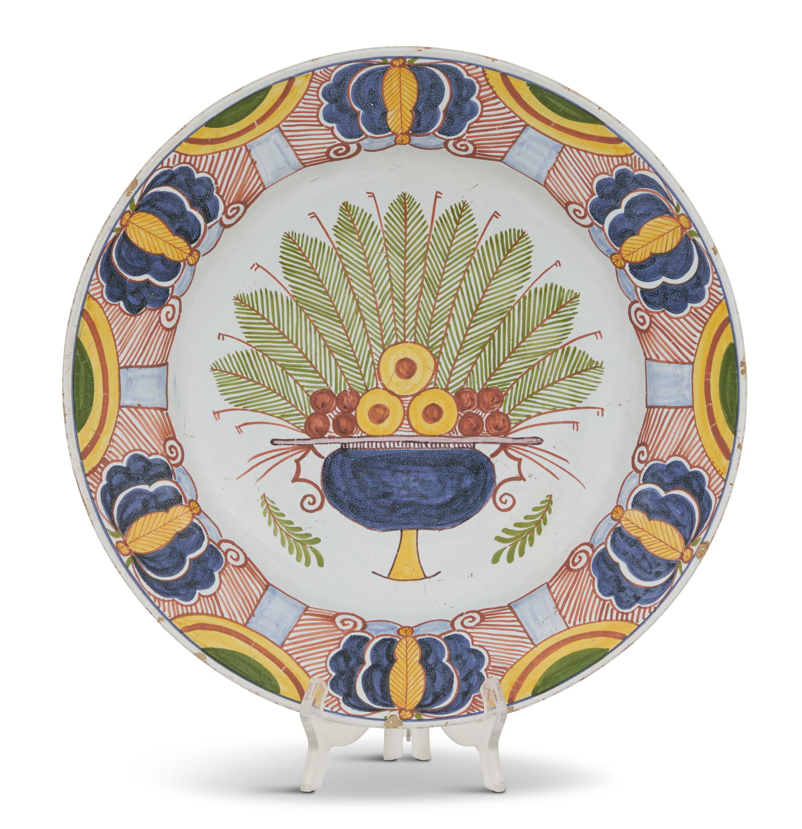 Dutch Polychrome Delftware Charger: Dutch Polychrome Delftware Charger ca. 1701-1722, decorated with an urn of palm fronds and fruit, the border with foliate decoration, marked by A. Pieter Kocx. dia. 13-3/4" Provenance: Kevin Stone