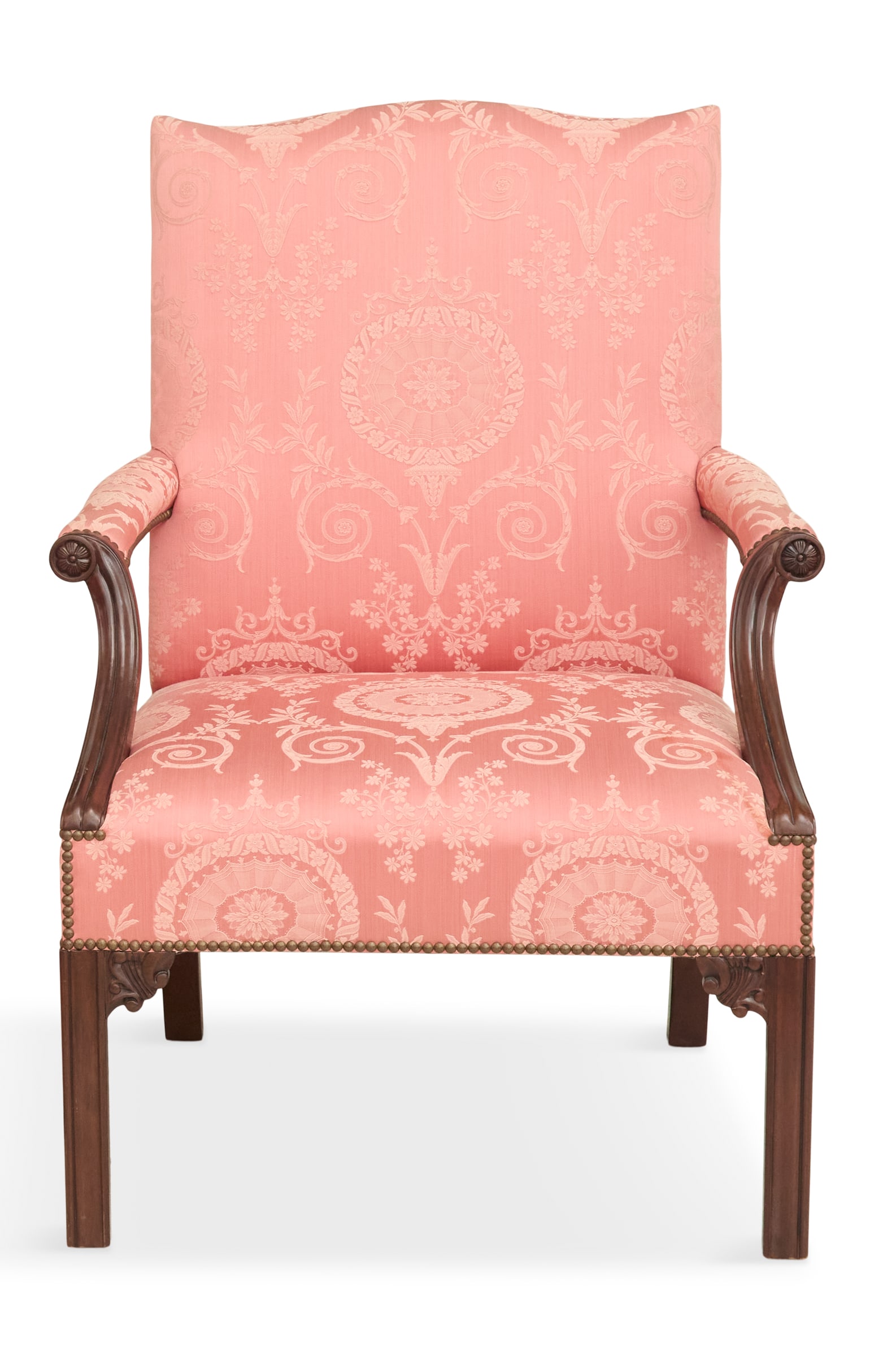 Mahogany Lolling Chair in the Chippendale Taste: Mahogany Lolling Chair in the Chippendale Taste20th century, the molded arms terminating in medallions, on Marlborough legs with scroll-carved corner brackets, upholstered in pink damask.h. 39-1/2", s
