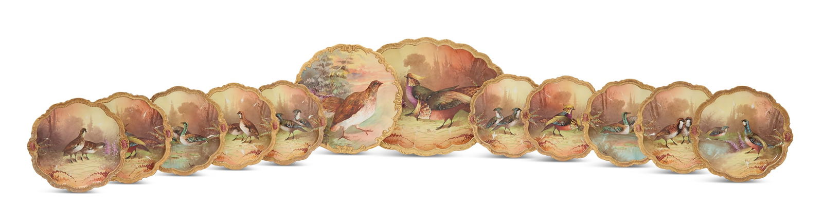 Twelve-Piece Limoges Porcelain Game Set: Twelve-Piece Limoges Porcelain Game Setca. 1906-1920, hand-painted with birds and raised scrolled borders, some artist-signed "Rene", on marked Coronet blanks, the set including an oval platter, w. 13