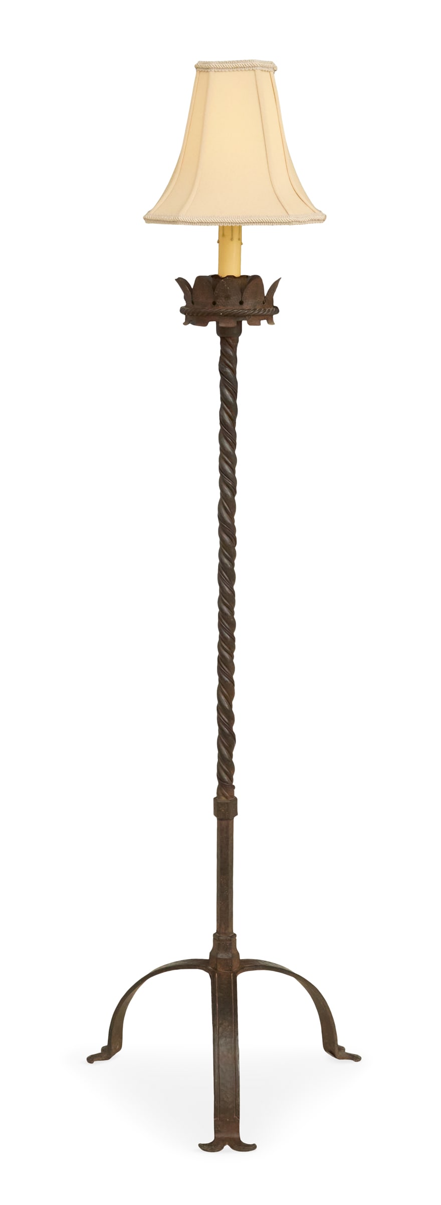 Metal Torchere Floor Lamp: Metal Torchere Floor Lampca. 1920-1940, the candle socket set into a crenelated drip pan, on a spiral-reeded standard, over an arched, hammered tripod base, electrified and fitted with a lampshade.h.