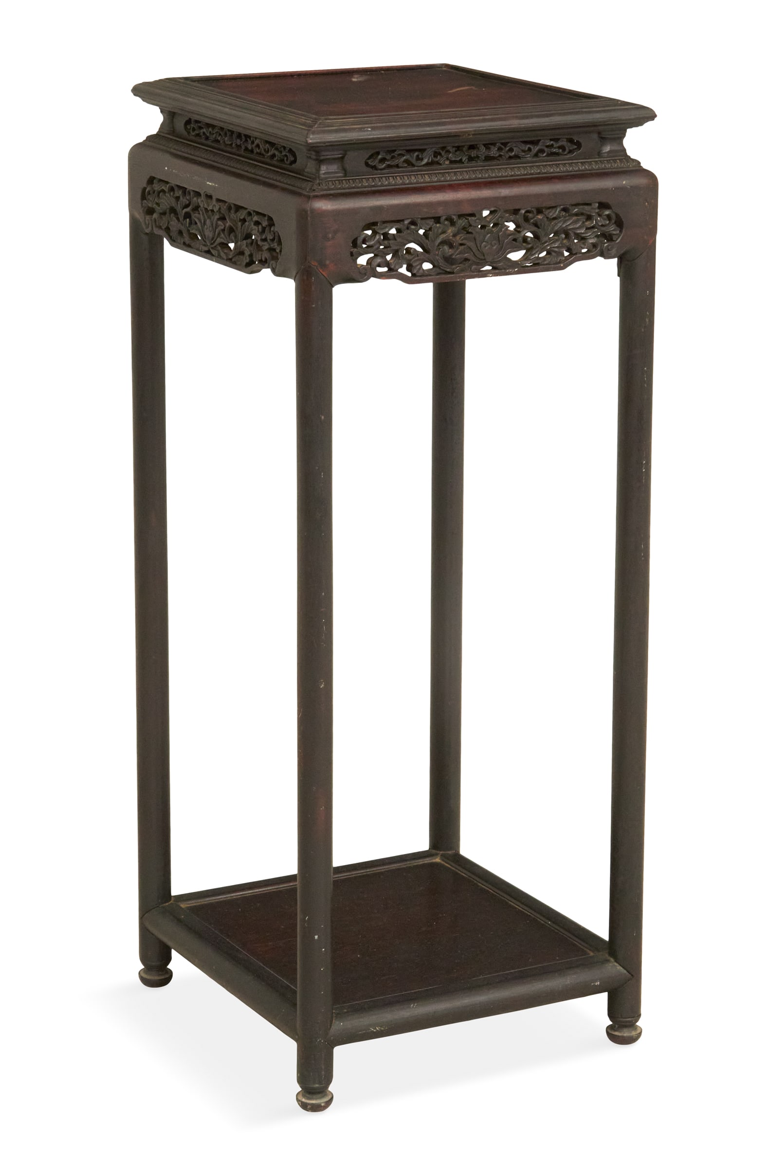Chinese Carved Rosewood Stand: Chinese Carved Rosewood Standca. 1900, the molded top supported on circular legs, each side decorated near the top with two graduated pierced panels carved with lotus flowers and scrollwork, with a lo