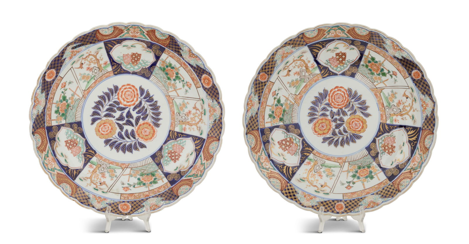 Pair of Japanese Imari Porcelain Chargers: Pair of Japanese Imari Porcelain Chargersca. 1900, the circular center panels decorated with flowers and leaves, the side panels decorated with pine trees, peonies, birds and butterflies, with scallop