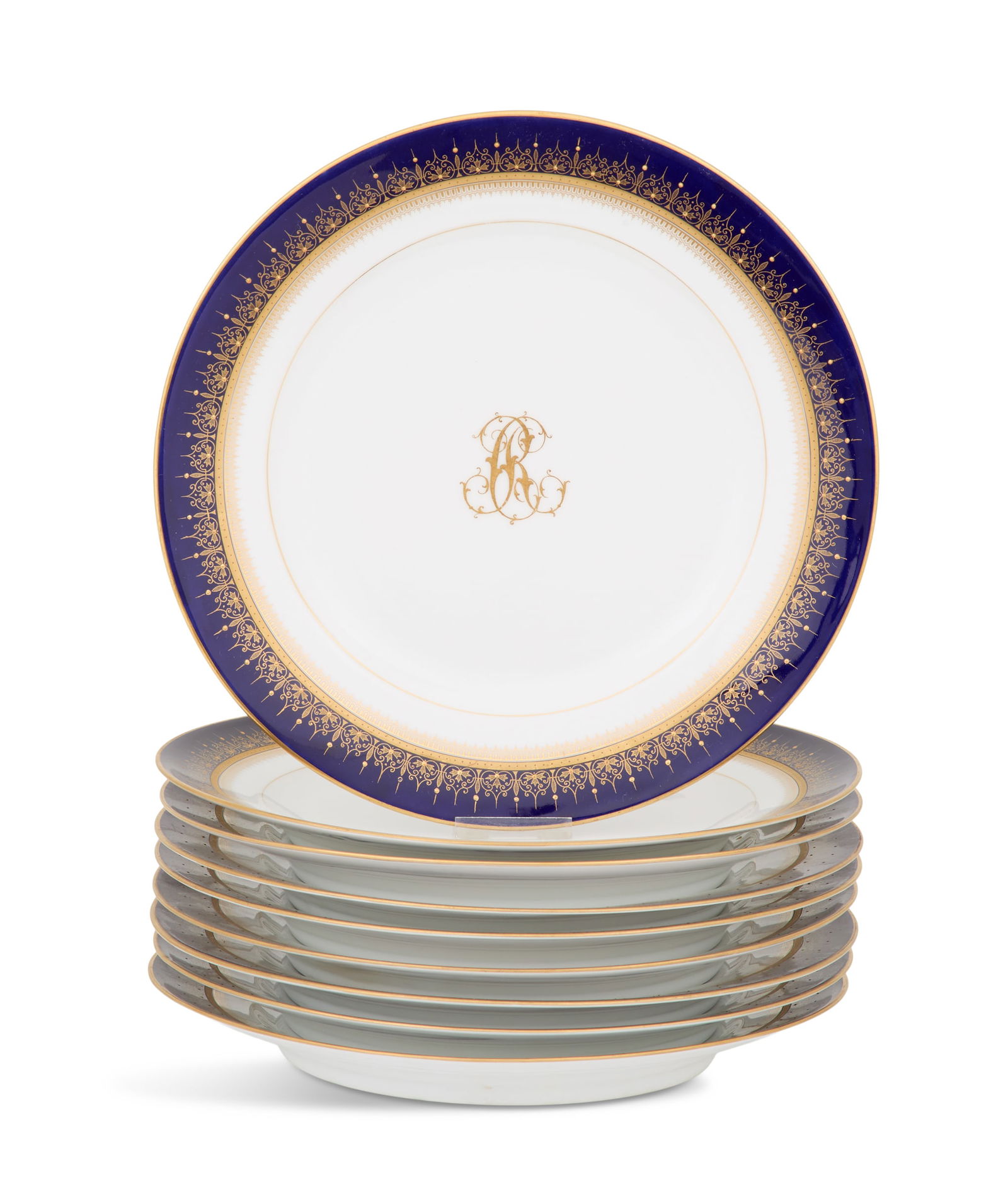 Set of Nine Porcelain Dinner Plates: Set of Nine Porcelain Dinner Plateslate 19th century, the plates decorated with gilt monograms in the center and cobalt borders with delicate raised gilt decoration, the backs with underglaze blue "be