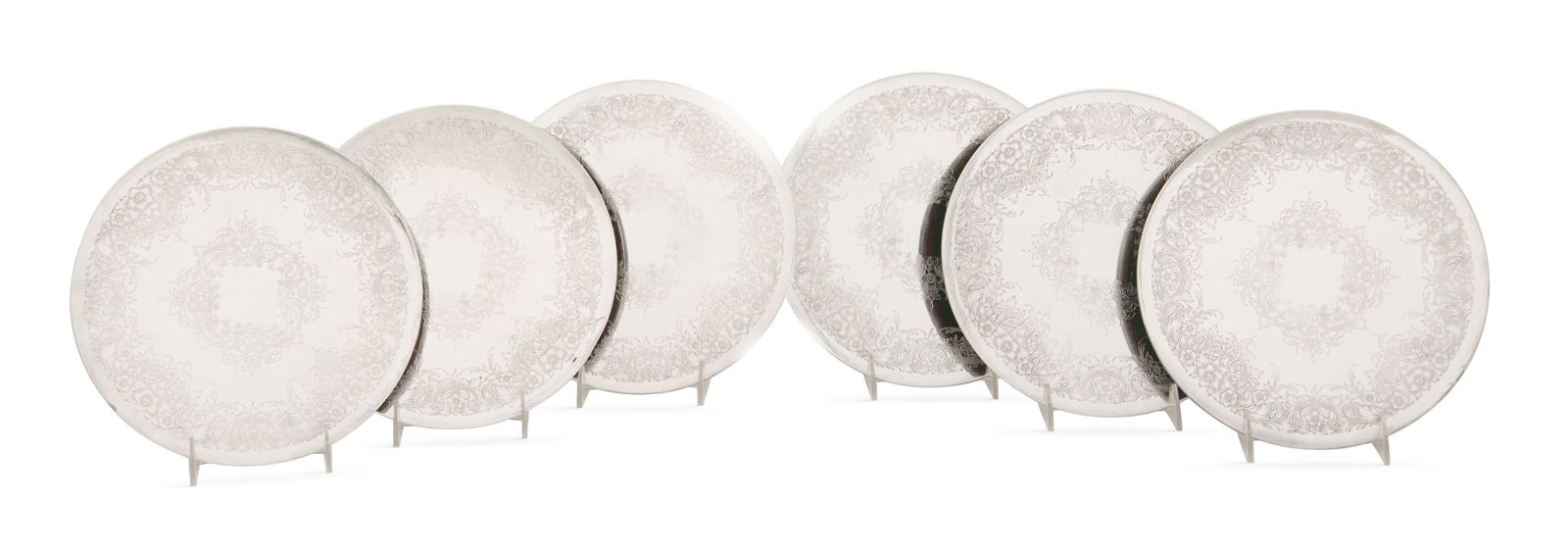Set of Six Silverplate-Clad Trivets: Set of Six Silverplate-Clad Trivets mid-20th century, unmarked, circular with wide floral scroll bands, with wood base. dia. 9-3/4"