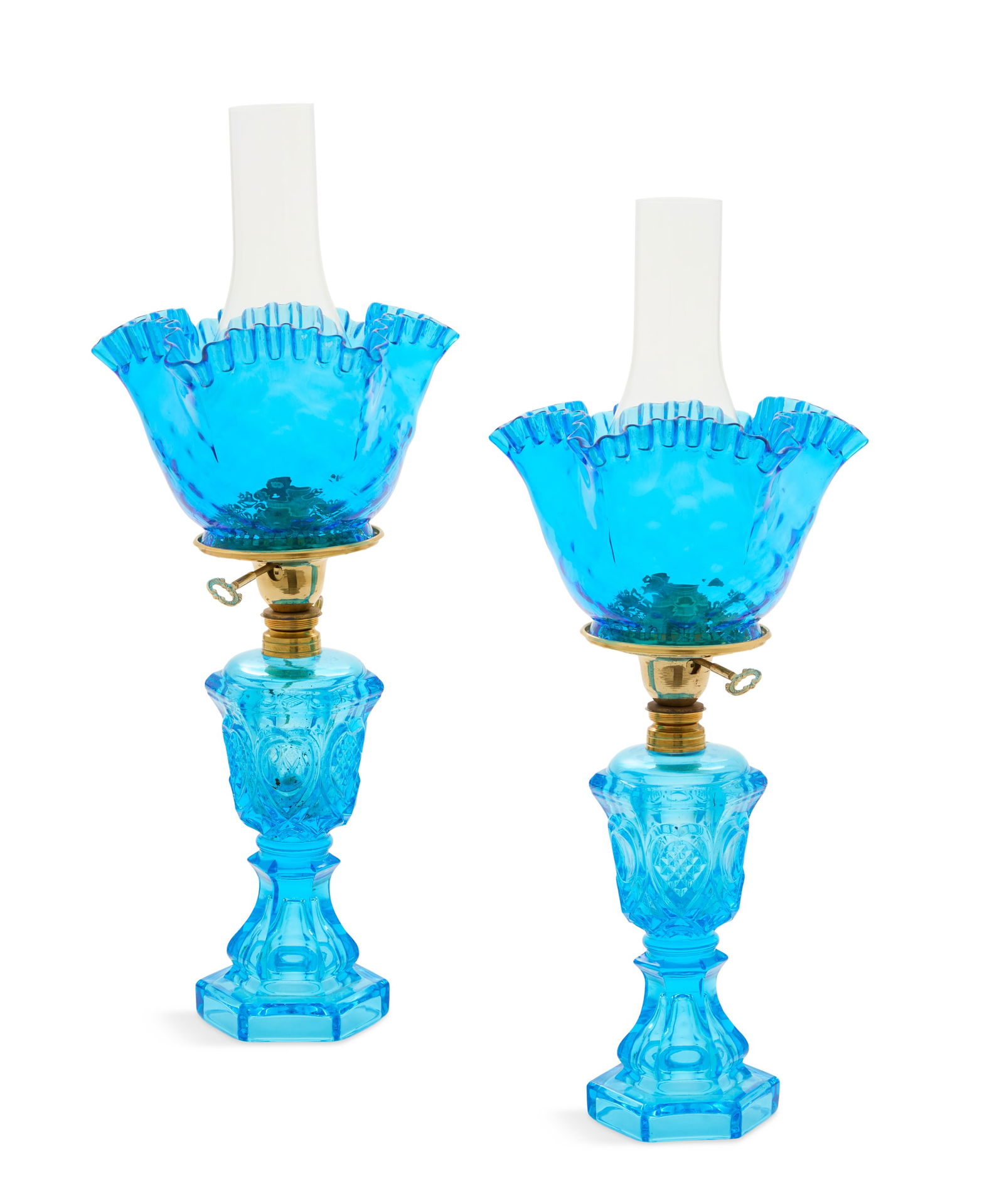 Pair of "Sweetheart" Pattern Fluid Lamps: Pair of "Sweetheart" Pattern Fluid Lamps now electrified, the ice-blue glass lamps with ruffled shades and chimneys, the brass collars marked with a patent date of "April 19, 1875", and "March 21,
