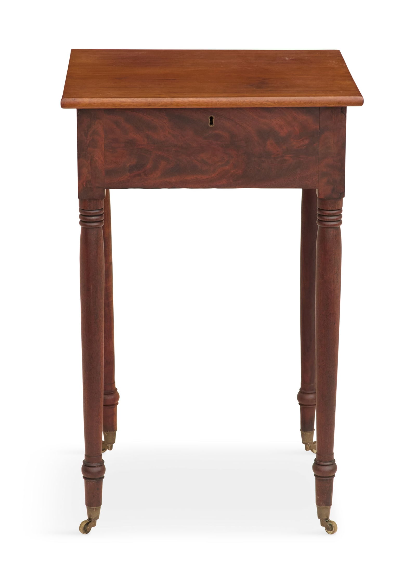 American Mahogany Lift-Top Work Table: American Mahogany Lift-Top Work Table19th century, the lift top opening to reveal fitted writing compartments, the skirt veneered in flame mahogany, on turned legs terminating in brass casters, one in