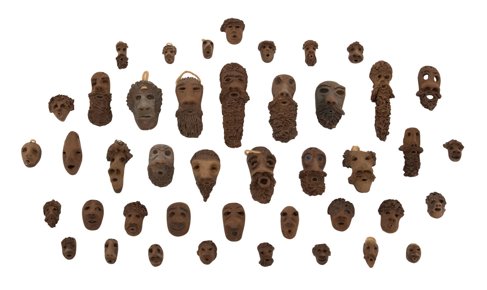 Rita Stelly Fontenot (USA/Louisiana, 1946-2003): Rita Stelly Fontenot(American/Louisiana, 1946-2003)"43 Faces"clay and stringmost signed en verso.ranging from 5-1/2" x 2" to 1" x 1" Provenance: The Collection of Norbert Deshotels, Lafayette, Louisia