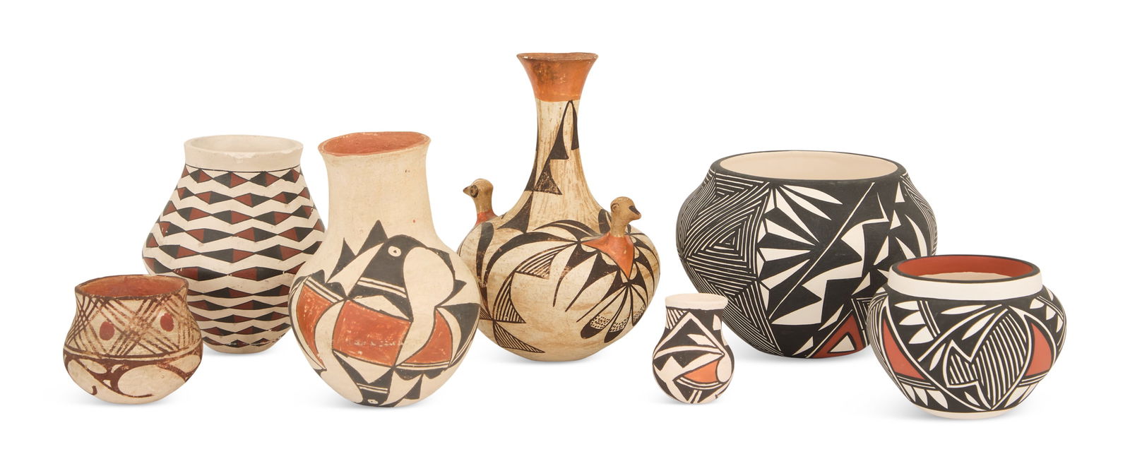 Seven Pieces of Acoma Pottery: Seven Pieces of Acoma Potteryincluding:a small olla, tan clay with white and rust slip decoration of hatched lines and suns, h. 2-1/4", dia. 3";a tall olla, tan clay with red and black lozenge banding