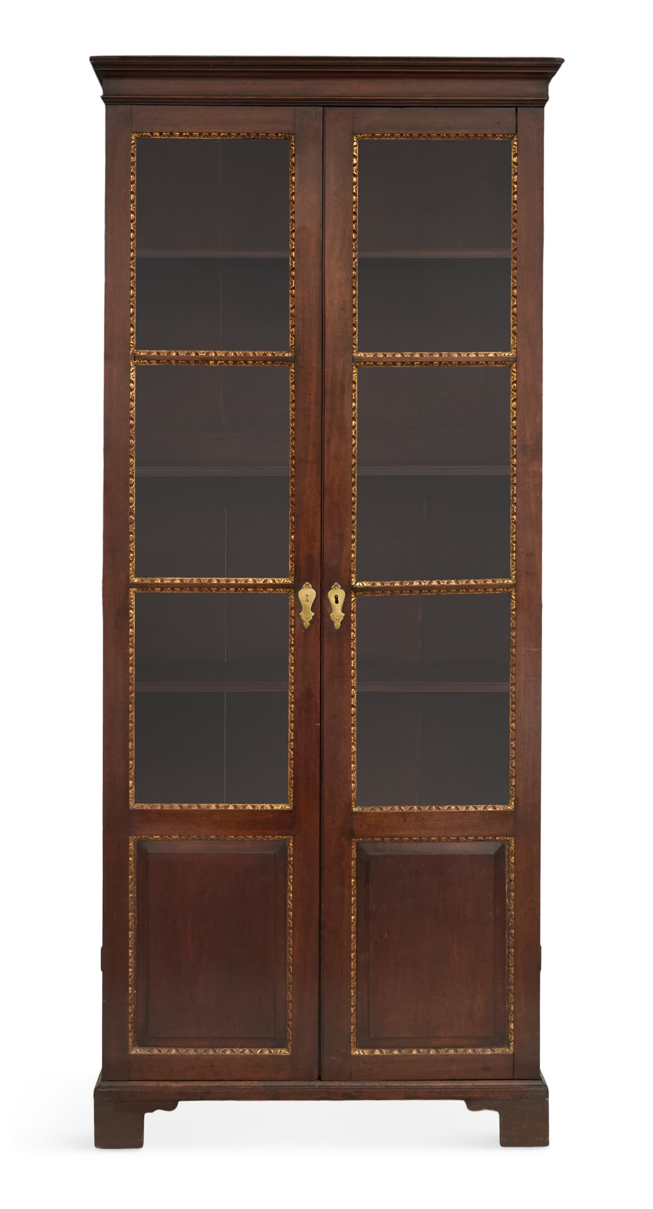 William IV Parcel-Gilt Mahogany Bibliotheque: William IV Parcel-Gilt Mahogany Bibliotheque 19th century, the molded cornice over a pair of glazed doors with egg-and-dart gilded trim, raised on bracket feet. h. 91-1/2", w. 39", d. 15" 