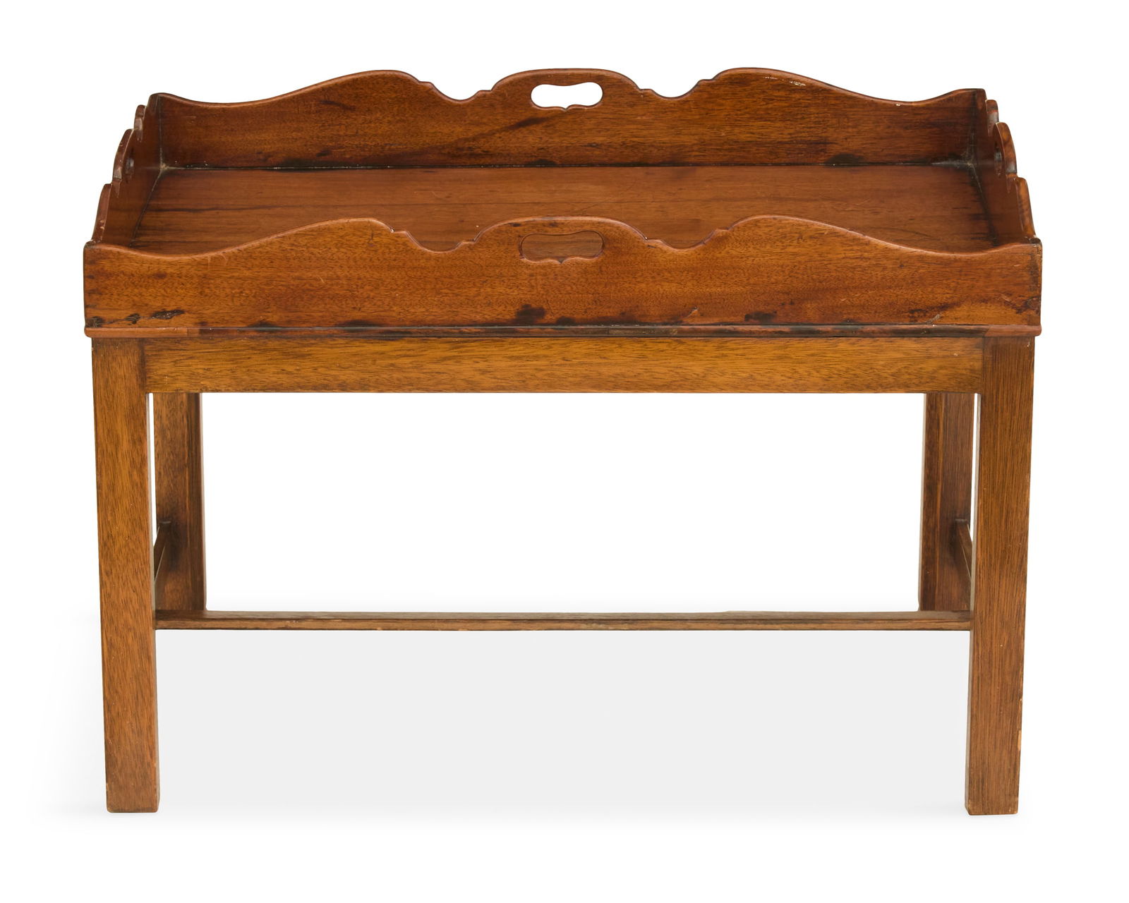 English Mahogany Butler's Tray on Stand: English Mahogany Butler's Tray on Stand19th century, the tray with a scalloped gallery and cut-out handles on all four sides, mounted to a George III-style stand with straight legs joined by an H-form
