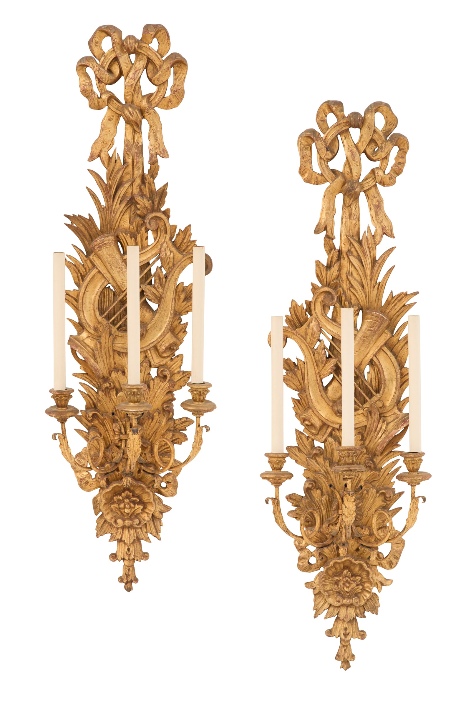 Pair of Italian Giltwood and Gilt-Metal Sconces: Pair of Large Italian Giltwood and Gilt-Metal Sconces20th century, the backplates carved with musical trophies and leaves, the lower portion with carved shells, set with leaf-ornamented, scrolled cand