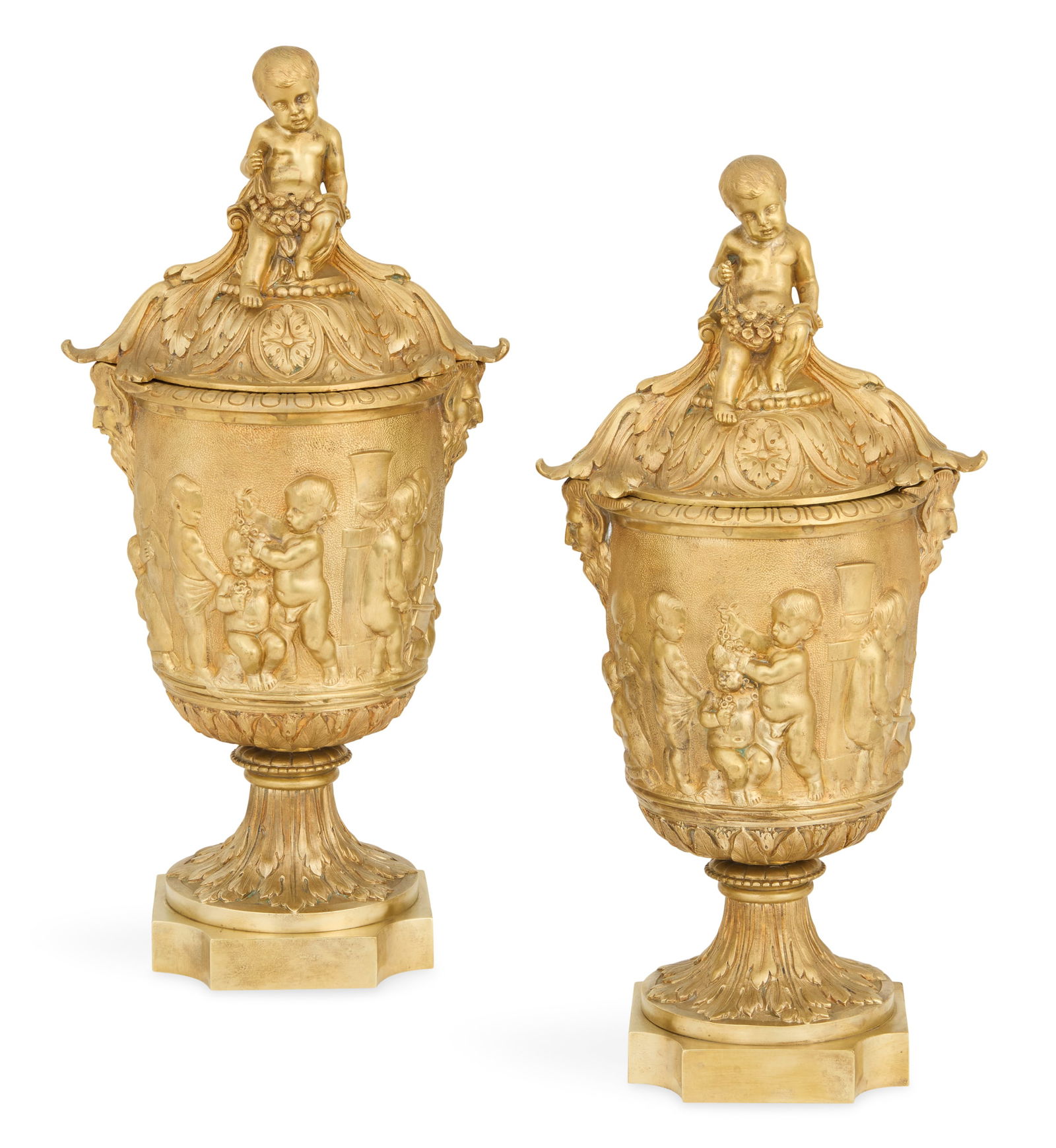Pair of French Gilt-Bronze Covered Urns: Pair of French Gilt-Bronze Covered Urns late 19th century, in the Belle Epoque taste, the ogee covers mounted with putti, supporting swags of flowers, the sides mounted with satyr heads and decorated