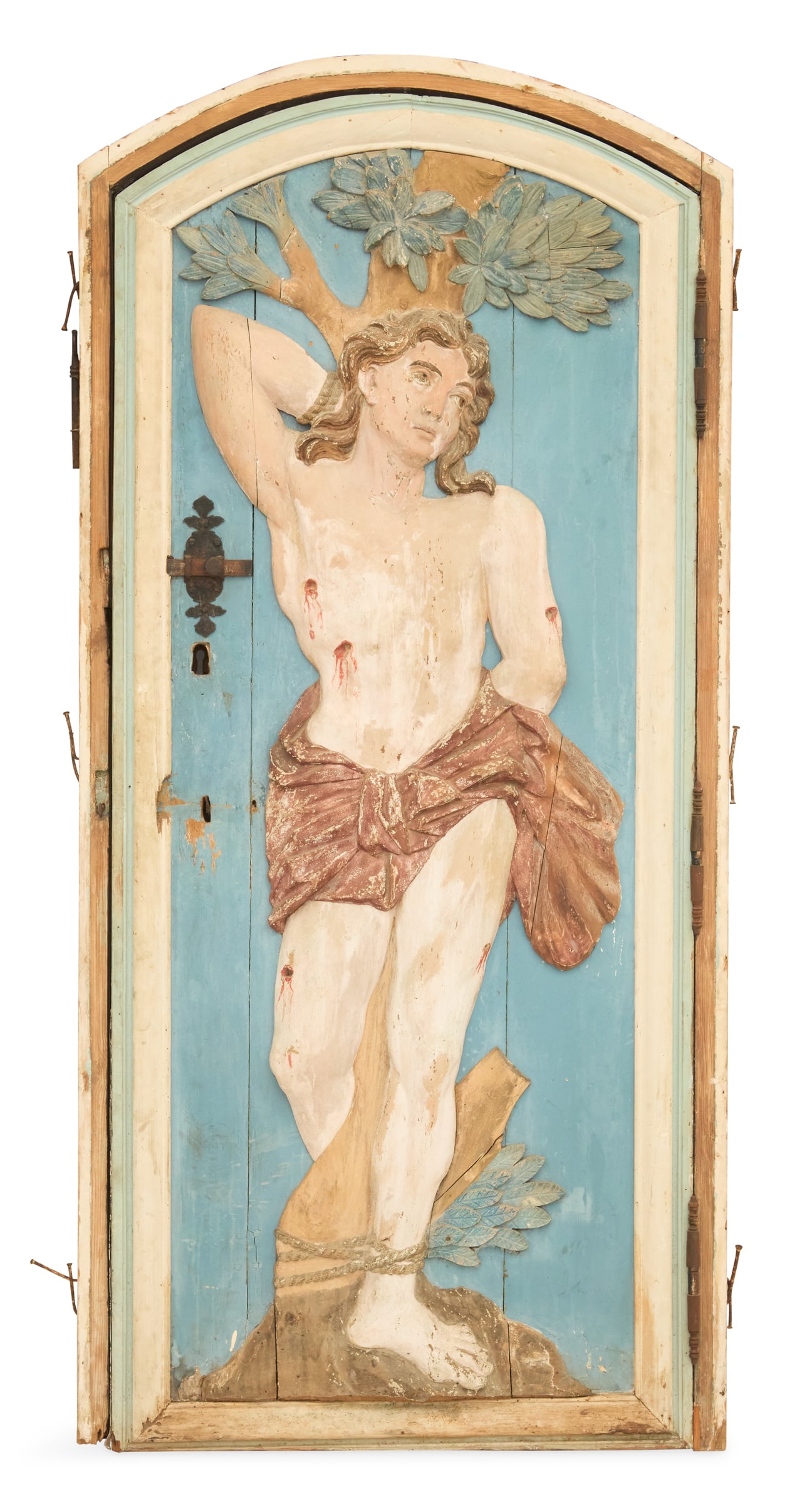 Unusual Belgian Carved Wood Door of St. Sebastian: Unusual Belgian Carved Wood Door of St. Sebastianearly 19th century, with an arched top and molded frame, bas-relief-carved with St. Sebastian tied to a tree, the back unadorned, the iron thumb latch