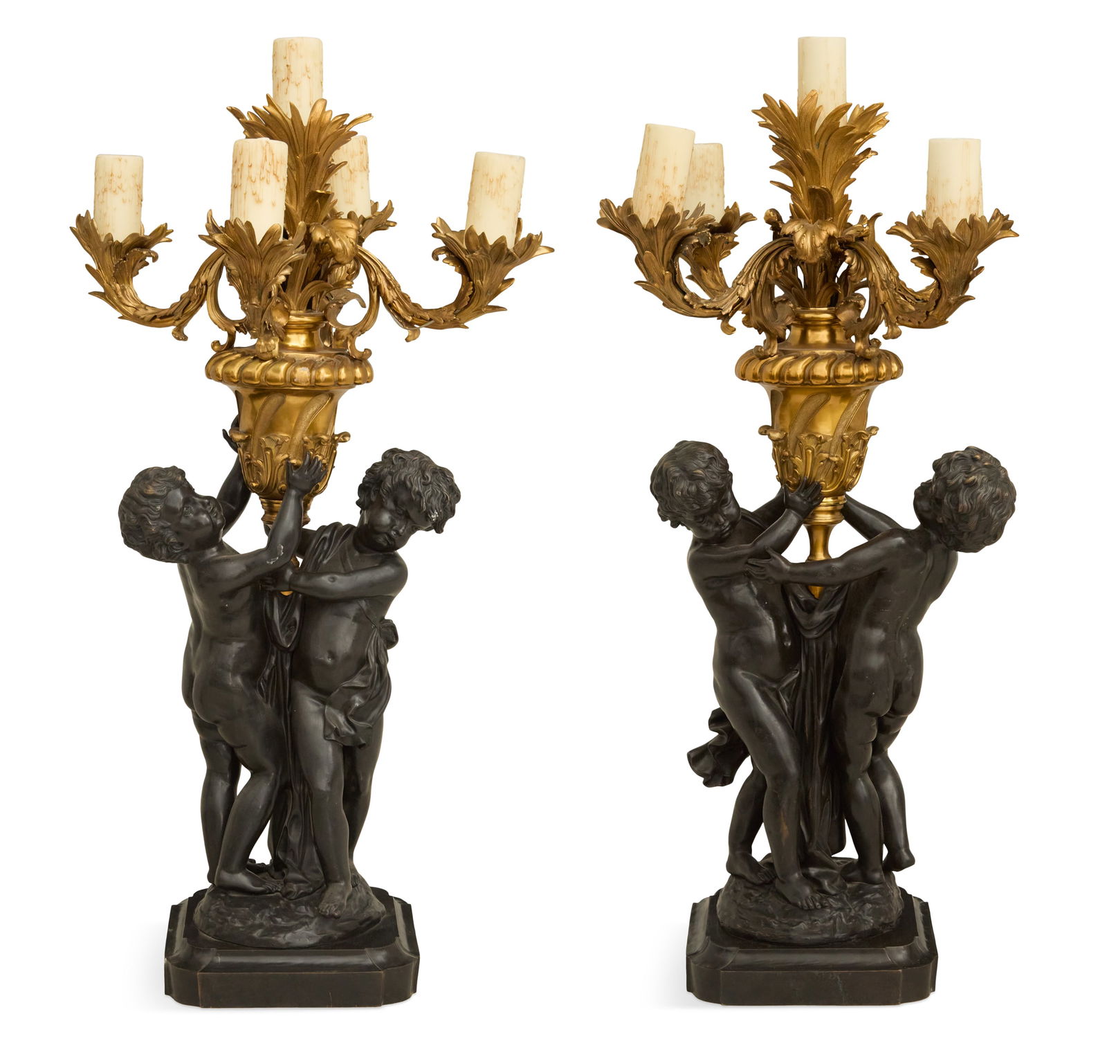 Pair of Bronze Dore et Patine Figural Torcheres: Pair of Bronze Dore et Patine Figural Torcheres20th century, in the Louis XV taste, the five leaf-molded candle branches set into spiral-reeded gilt-bronze urns, held aloft by pairs of bronze patine c