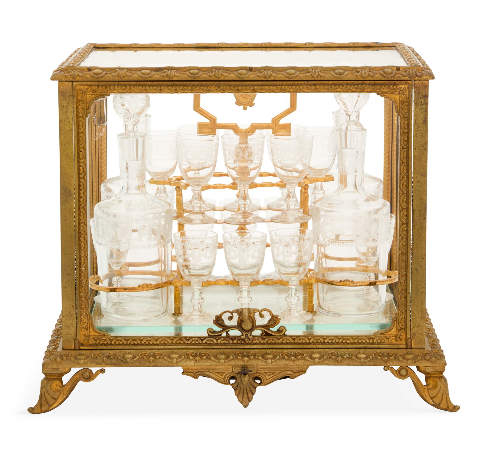 French Gilt-Bronze and Crystal Cave a Liqueur: French Gilt-Bronze and Crystal Cave a Liqueurlate 19th century, the glass-mounted gilt-bronze case molded with scrollwork and cabochons, raised on scrolled feet, with a mirrored bottom, the gilt-bronz