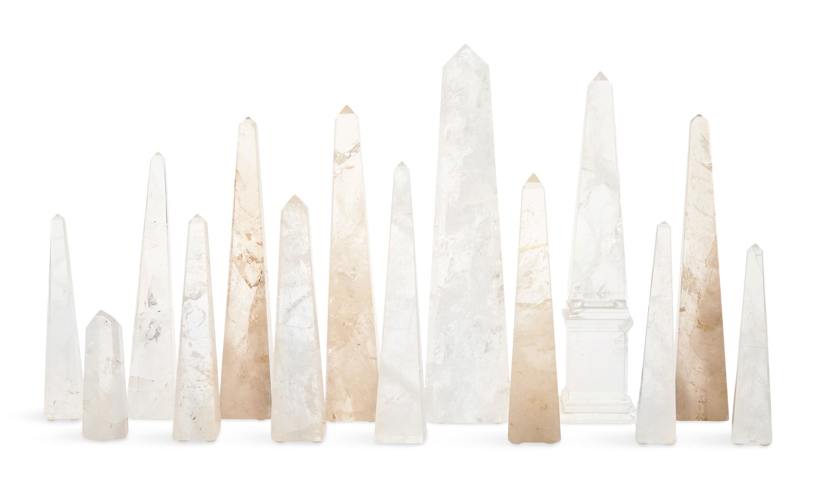 Collection of Fourteen Rock Crystal Obelisks: Collection of Fourteen Rock Crystal Obelisksincluding one obelisk supported on spherules atop a rectangular base, one prism-form example and the others in the traditional form.h. 5" to 15", w. 1-1/2"