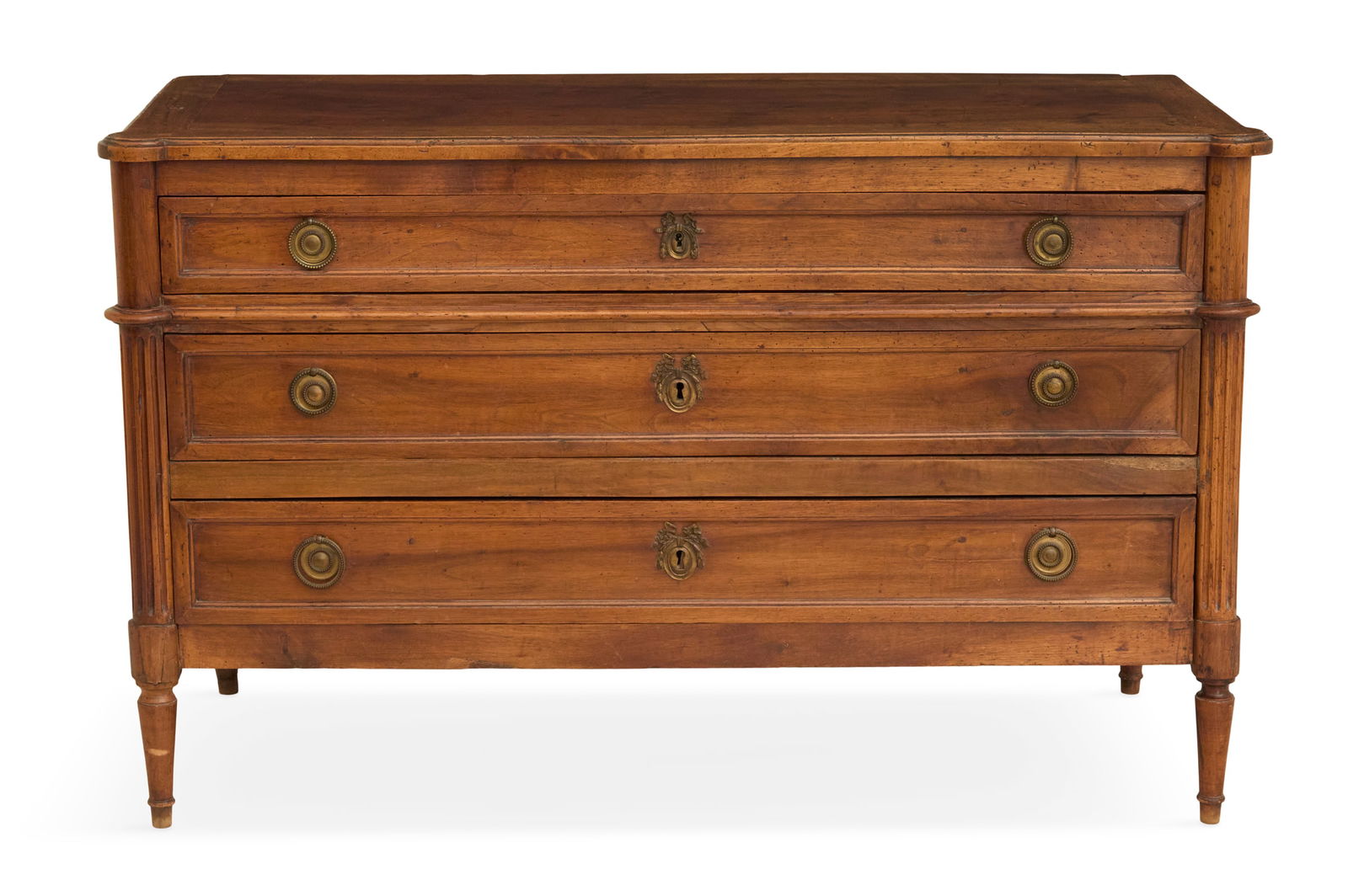 Directoire Walnut Commode: Directoire Walnut Commodeca. 1800, the framed flush-panel top with cookie corners, over three long drawers flanked by fluted corner columns, raised on turned legs.h. 31-1/2", w. 50", d. 22" Provenance