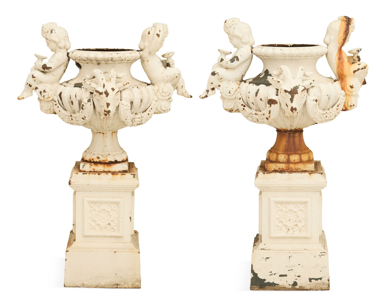 Pair of French Cast-Iron Figural Garden Urns: Pair of French Cast-Iron Figural Garden Urnslate 19th century, the reeded urns mounted on two sides with Bacchanalian putti holding kylixes, and ram's heads on the other sides, with swags of fruit in