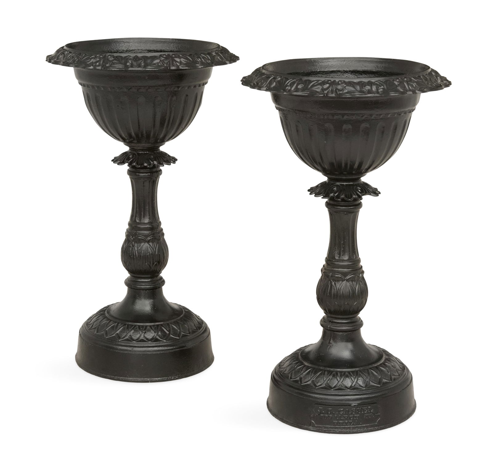 Pair of American Labeled Cast-Iron Urns: Pair of American Labeled Cast-Iron Urnslate 19th century, Philadelphia, the scroll-molded rims over fluted bodies, supported on vasiform standards decorated with fluting and molded lotus leaves, the b