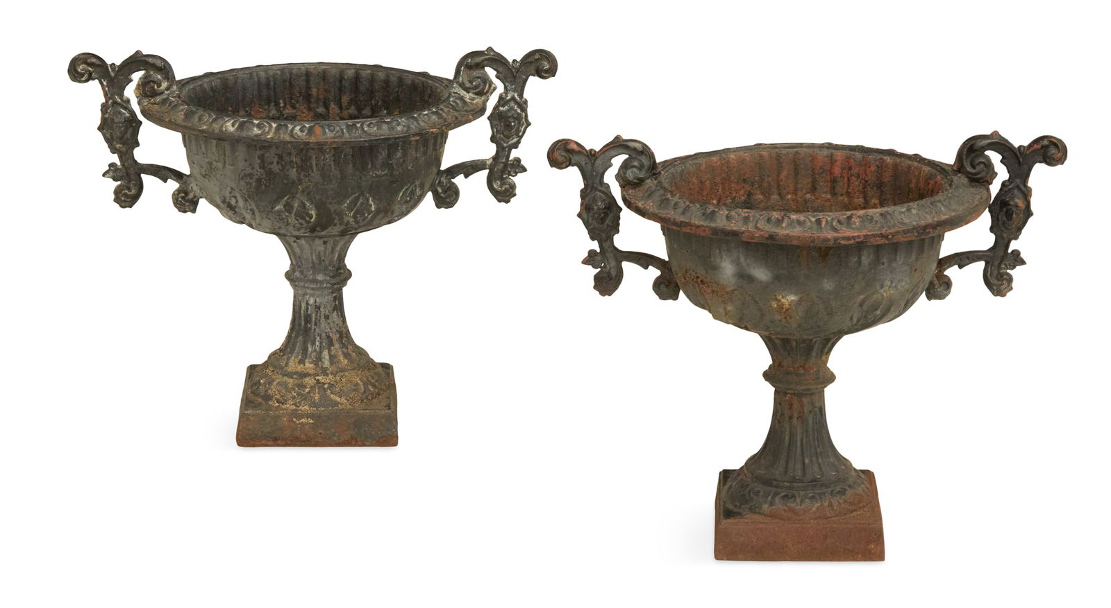 Pair of Cast-Iron Garden Urns: Pair of Cast-Iron Garden Urnsfourth quarter 19th century, in the Renaissance Revival taste, the rocaille-molded rims over bodies decorated with inset panels of molded grapes, the handles decorated wit