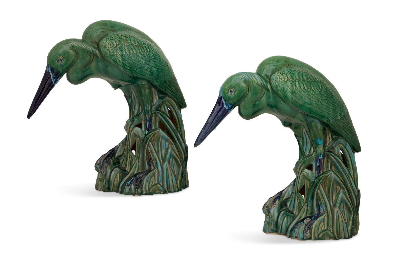 Pair of Glazed Terracotta Herons: Pair of Glazed Terracotta Herons20th century, the green-glazed herons with cobalt beaks and legs, "walking" in aquatic grass.h. 23-1/2", w. 8", d. 24"
