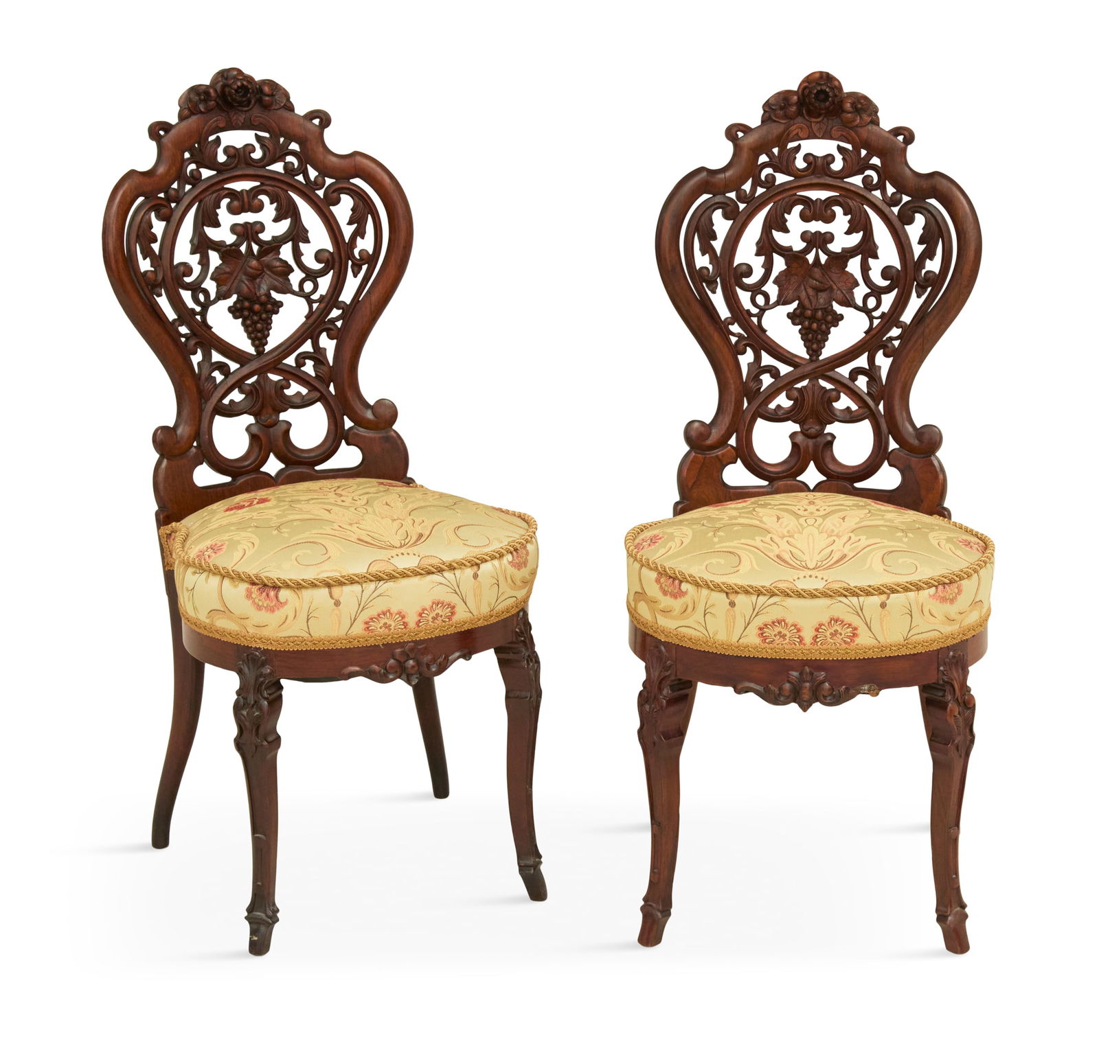 Pair of Rococo Revival Rosewood Side Chairs: Pair of Rococo Revival Laminated Rosewood Side Chairsmid-19th century, attributed to J. & J.W. Meeks, New York, each with a pierced and carved back, floral crest and scrolled details, centered with a