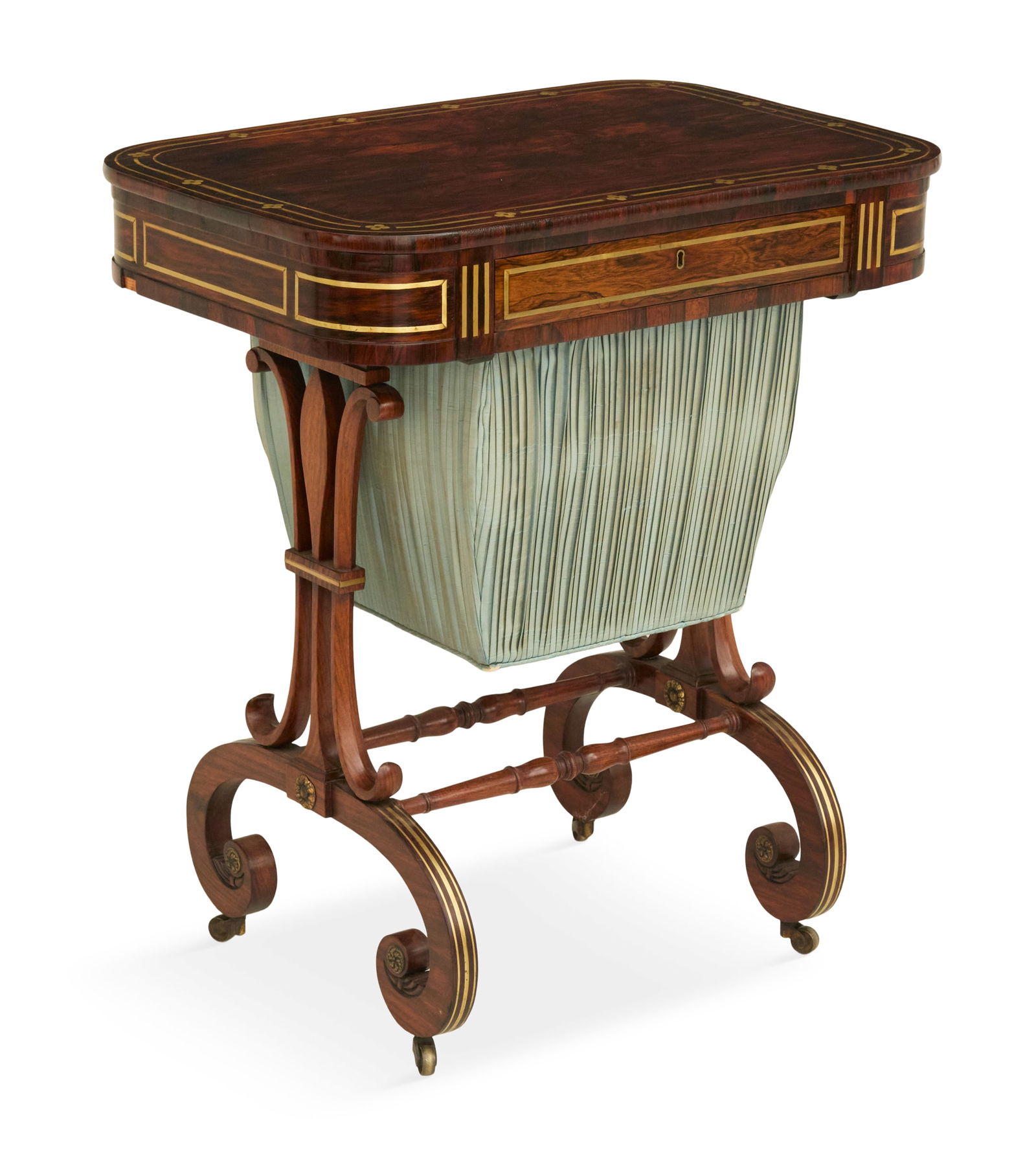 Fine Regency Brass-Inlaid Rosewood Sewing Table: Fine Regency Brass-Inlaid Rosewood Sewing Table 19th century, the top with rounded corners and brass-inlaid border, above a single drawer and silk-covered bin below, raised on scrolled legs with