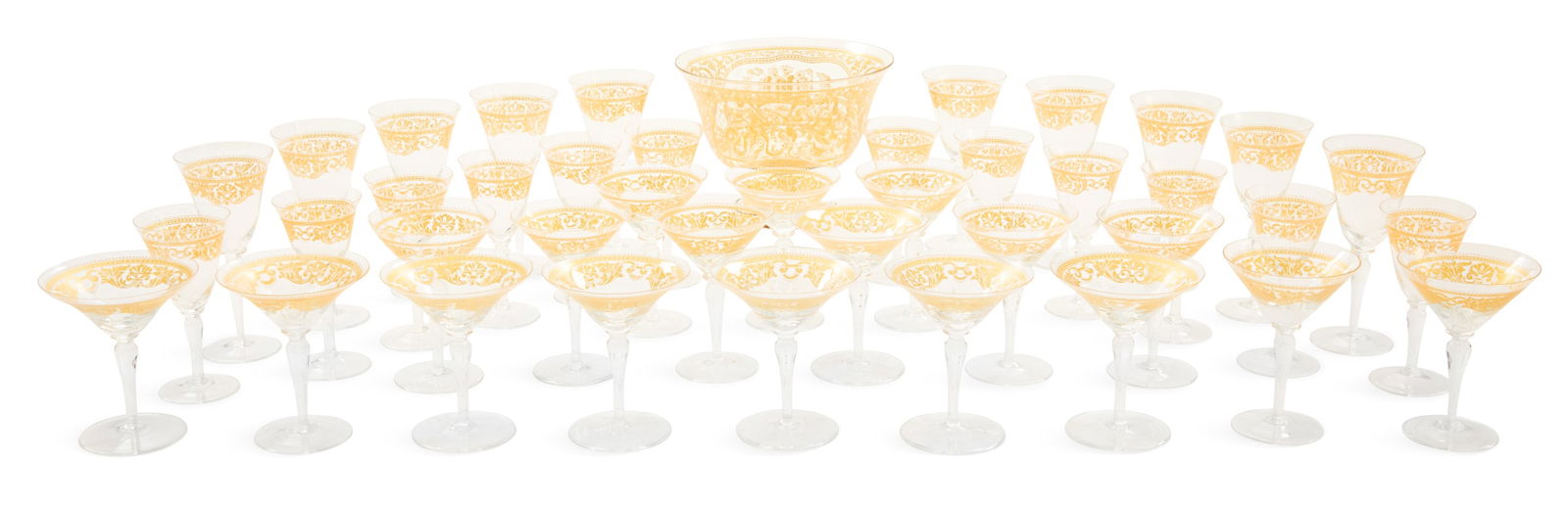 Italian Gilt-Decorated Glass Stemware: Partial Service of Italian Gilt-Decorated Glass Stemware20th century, all with gilt borders decorated with anthemia and scrollwork, accented with white enamel beading, the footed bowl the large center
