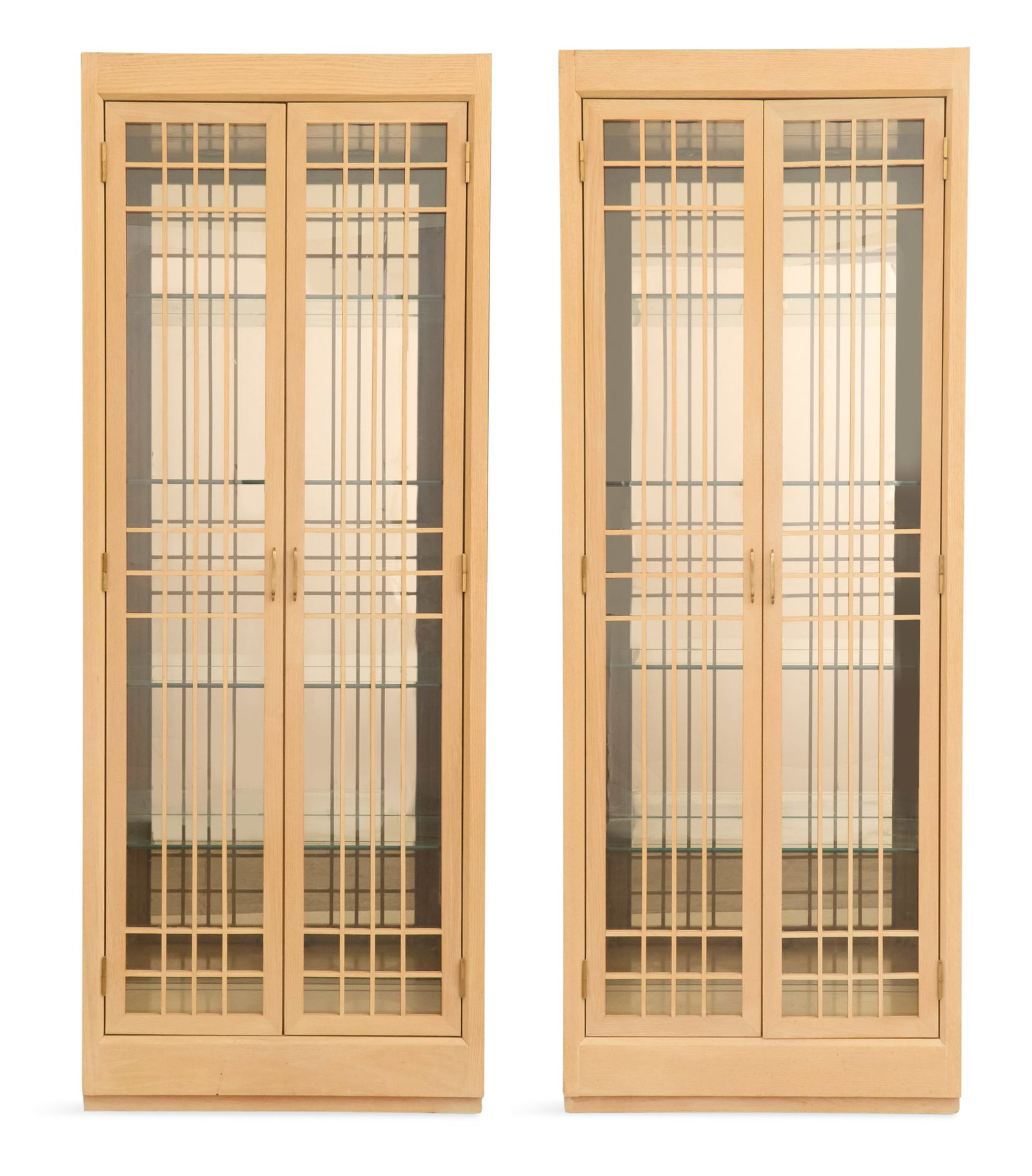 Pair of Arts and Crafts-Style Display Cabinets: Pair of Arts and Crafts-Style Oak Display Cabinetsin the manner of Stickley, each with a pair of full-length doors with muntin grilles, the sides of like design, the interiors lighted and with mirrore