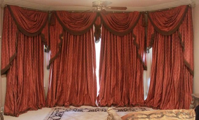Set of Iridescent Coral Silk Curtains & Valances: Set of Iridescent Coral Silk Curtains and Valances, including two pleated single-width valances with swags and jabots, h. 7-3/4", l. 48-1/2", a double-width cornice board with two swags and matching j