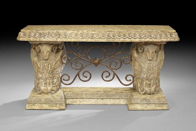 Italian Neoclassical-Style Console: Italian Neoclassical-Style Faux Travertine Console, the bowed top supported by a pair of allegorical winged pedestals, each with ram's heads and joined by wrought iron scrollwork, h. 36-1/4", w. 69",