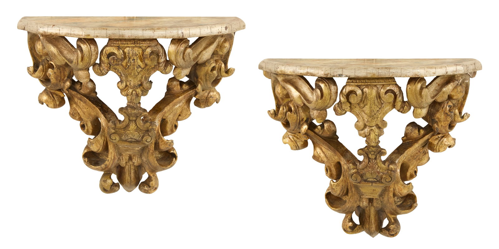 Pair of Italian Giltwood Brackets: Pair of Italian Giltwood Brackets 19th century, in the Baroque style, the faceted shelves decorated with faux marbre with silver gilt edges, supported on bold leaf-carved scrollwork and rocaille work,