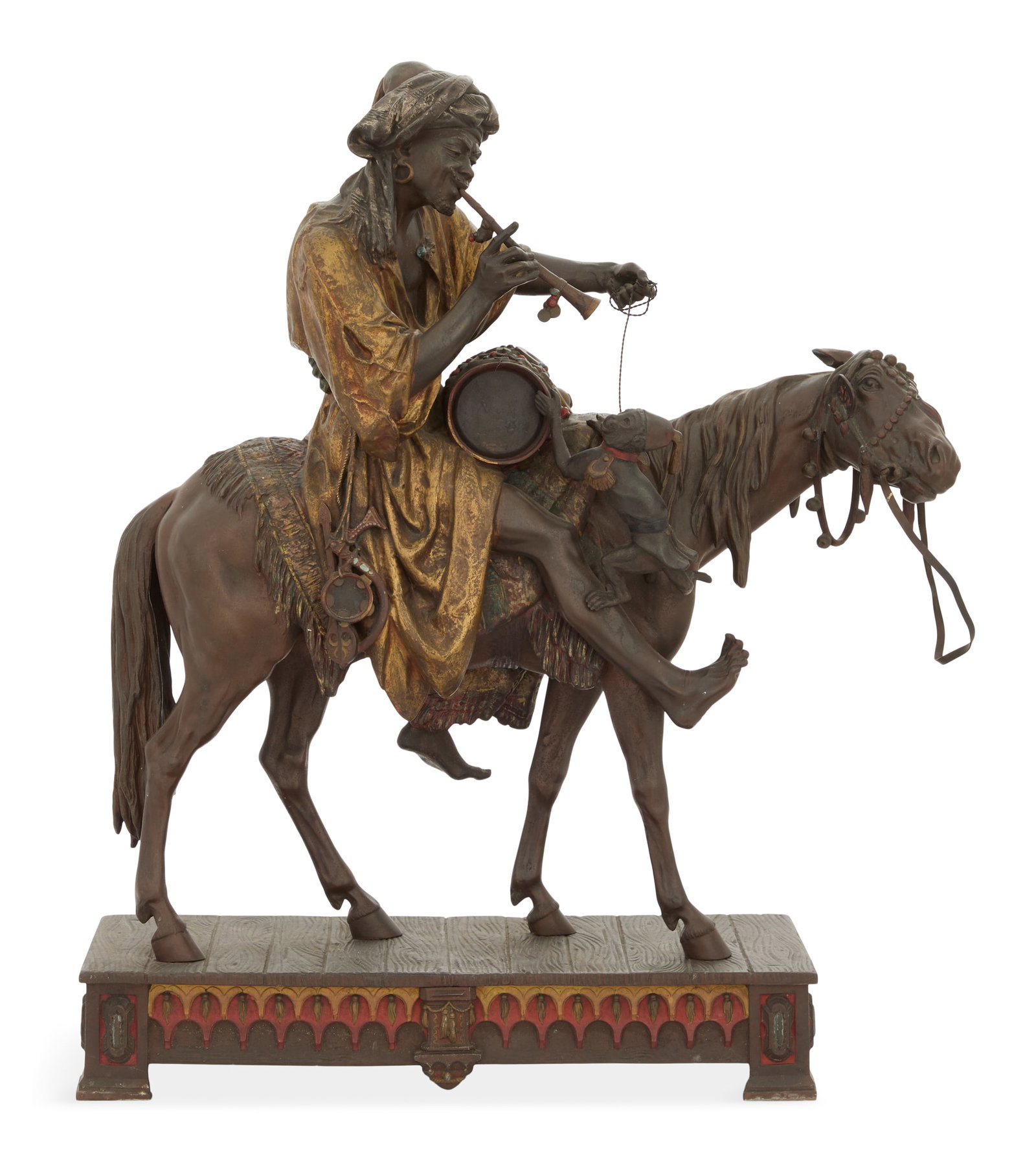 Viennese Enameled Metal Figure of a Moor: Viennese Enameled Metal Figure of a Moor on Horseback early 20th century, Vienna, the Moor in desert garb, a drum across his saddle, playing a flute to a monkey, on a jugendstil-style base, signed ill
