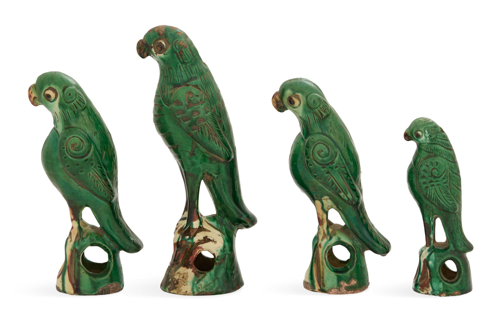 Four Chinese Sancai-Glazed Pottery Parrots: Four Chinese Sancai-Glazed Pottery Parrots late 19th century, the green-glazed bodies with incised details, over pierced bases with green, yellow and brown glazes. h. 5-1/2" to 8-1/2", dia. 2" to 2-1/