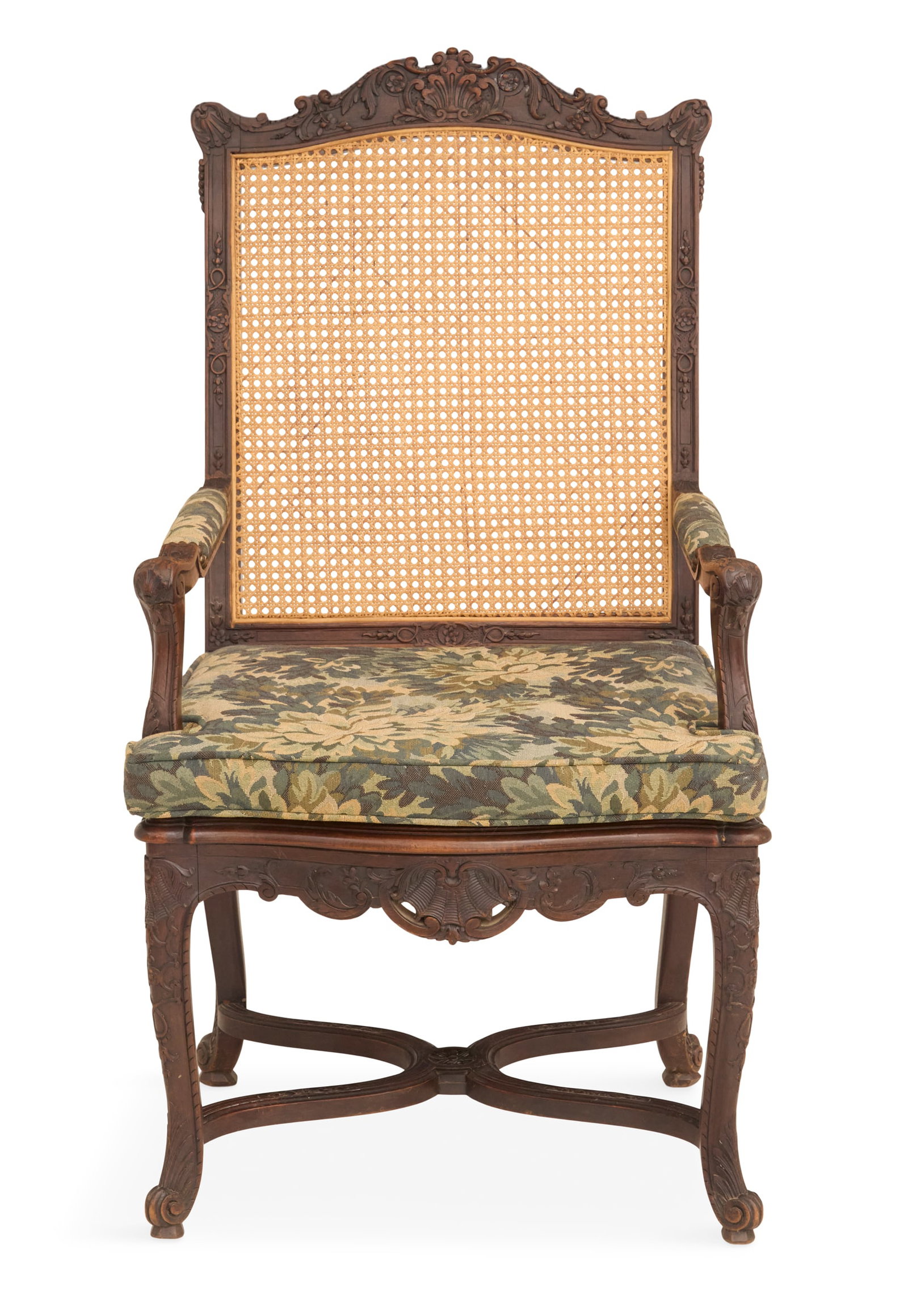 French Carved Walnut Armchair: French Carved Walnut Armchair 19th century, with a caned back and seat and carved back and legs, joined by an X-form stretcher, fitted with a loose seat cushion. h. 45-1/2", seat h. 20-1/2", w. 25", d