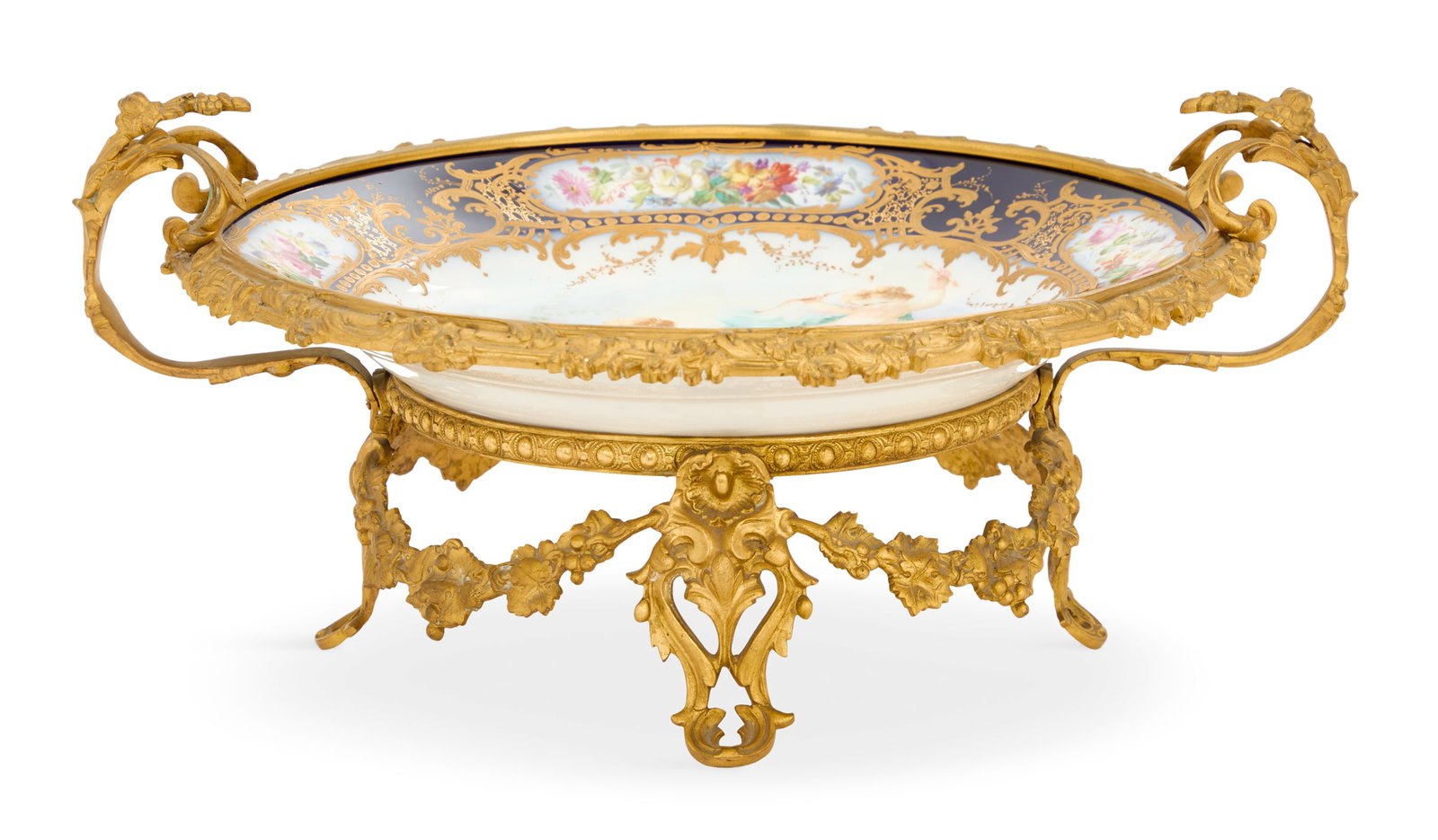French Belle Epoque Centerpiece: French Belle Epoque Porcelain and Bronze Centerpiece ca. 1900, the Limoges porcelain insert decorated with cherubs and cobalt blue borders with panels of flowers and raised gilt, set into a bronze flo