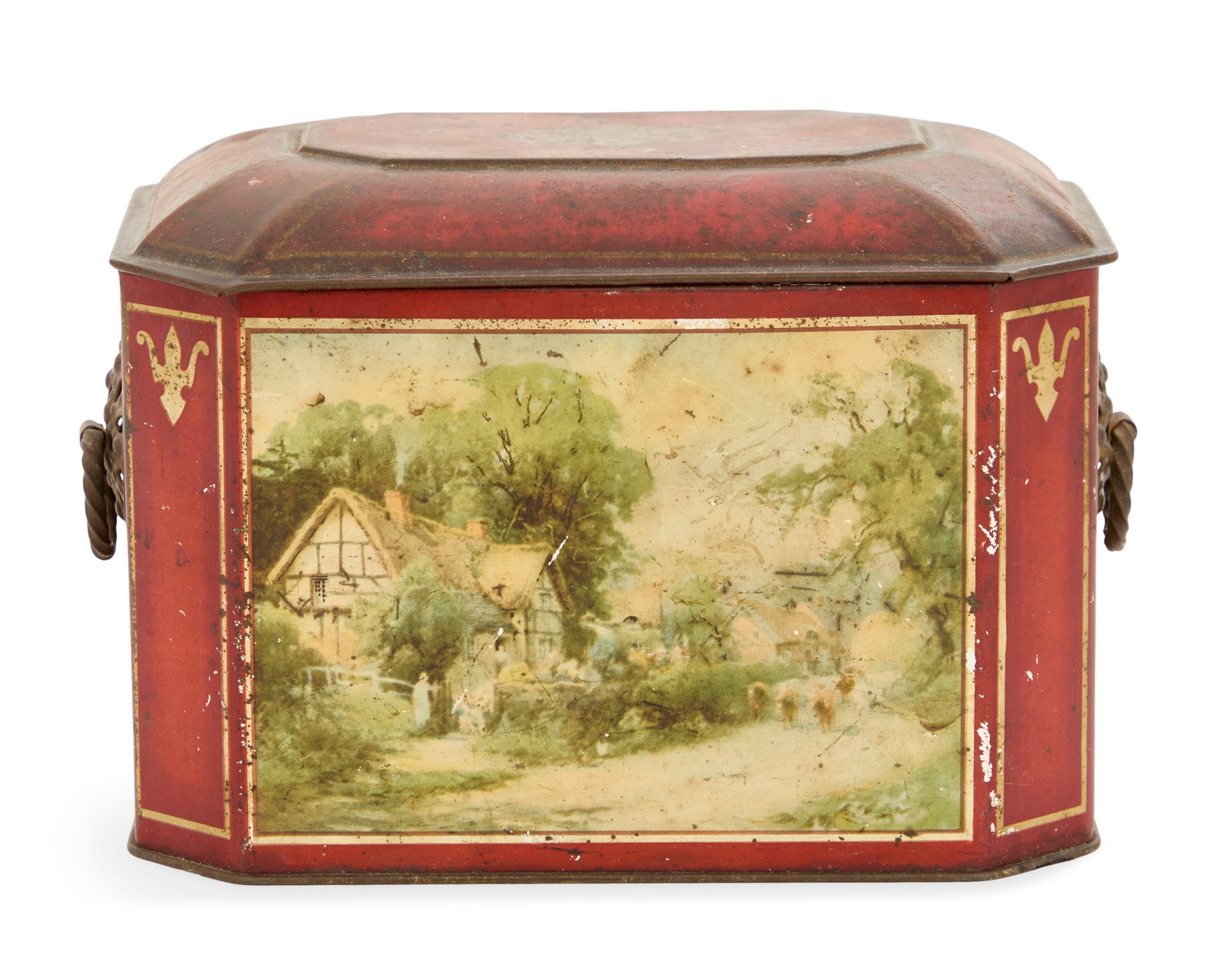 English Tole Biscuit Tin: English Tole Biscuit Tin early 20th century, transfer-printed with bucolic scenes of thatched cottages on a red ground, the sides with ring handles. h. 5", w. 6-3/4", d. 4-3/4" Provenance: The collect