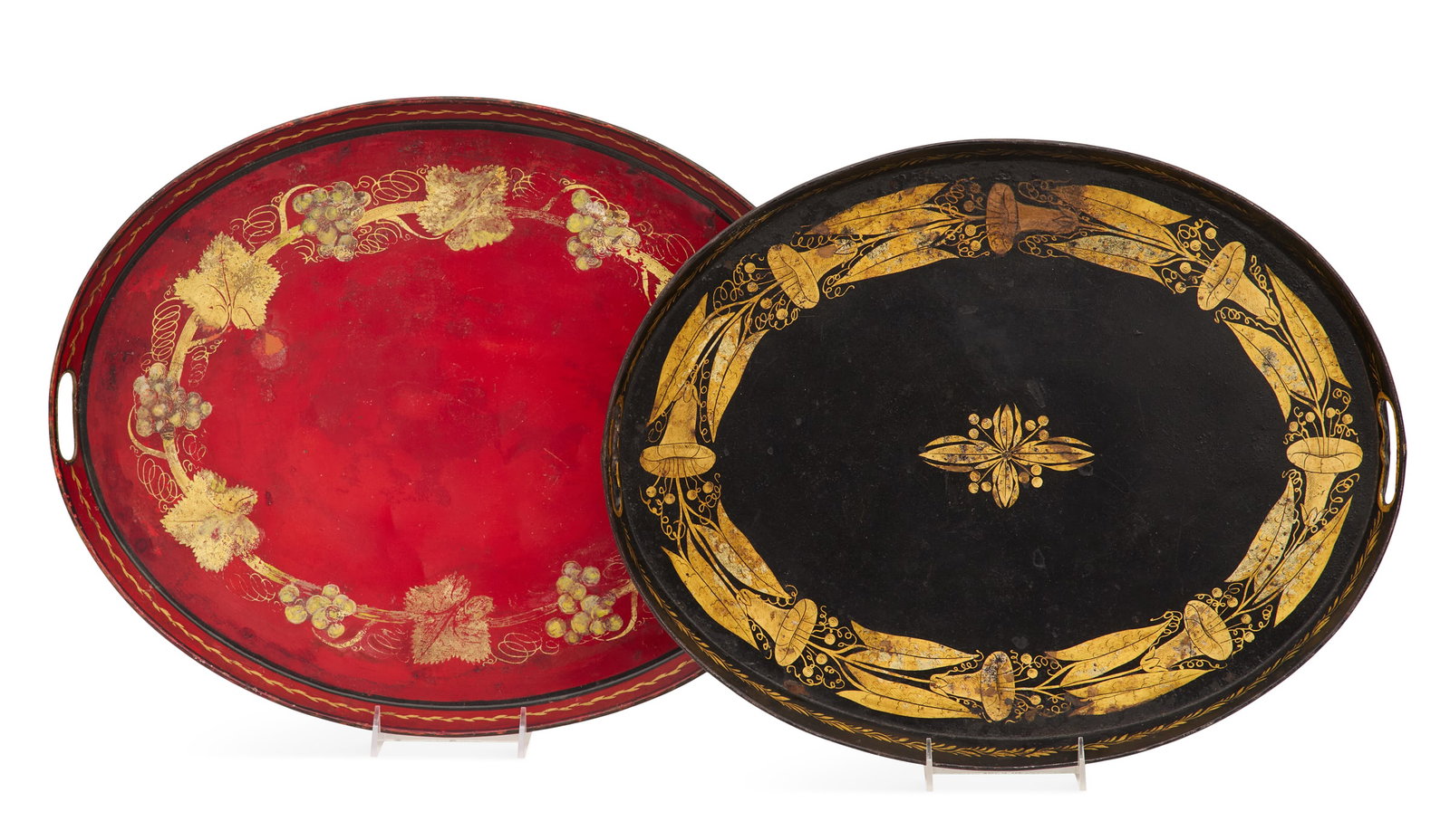 Two English Tole Oval Gallery Trays: Two English Tole Oval Gallery Trays early 19th century, each with pierced handles, including a red example decorated with gilt grapevines, w. 16-1/4", l. 20", and a black example decorated with mornin