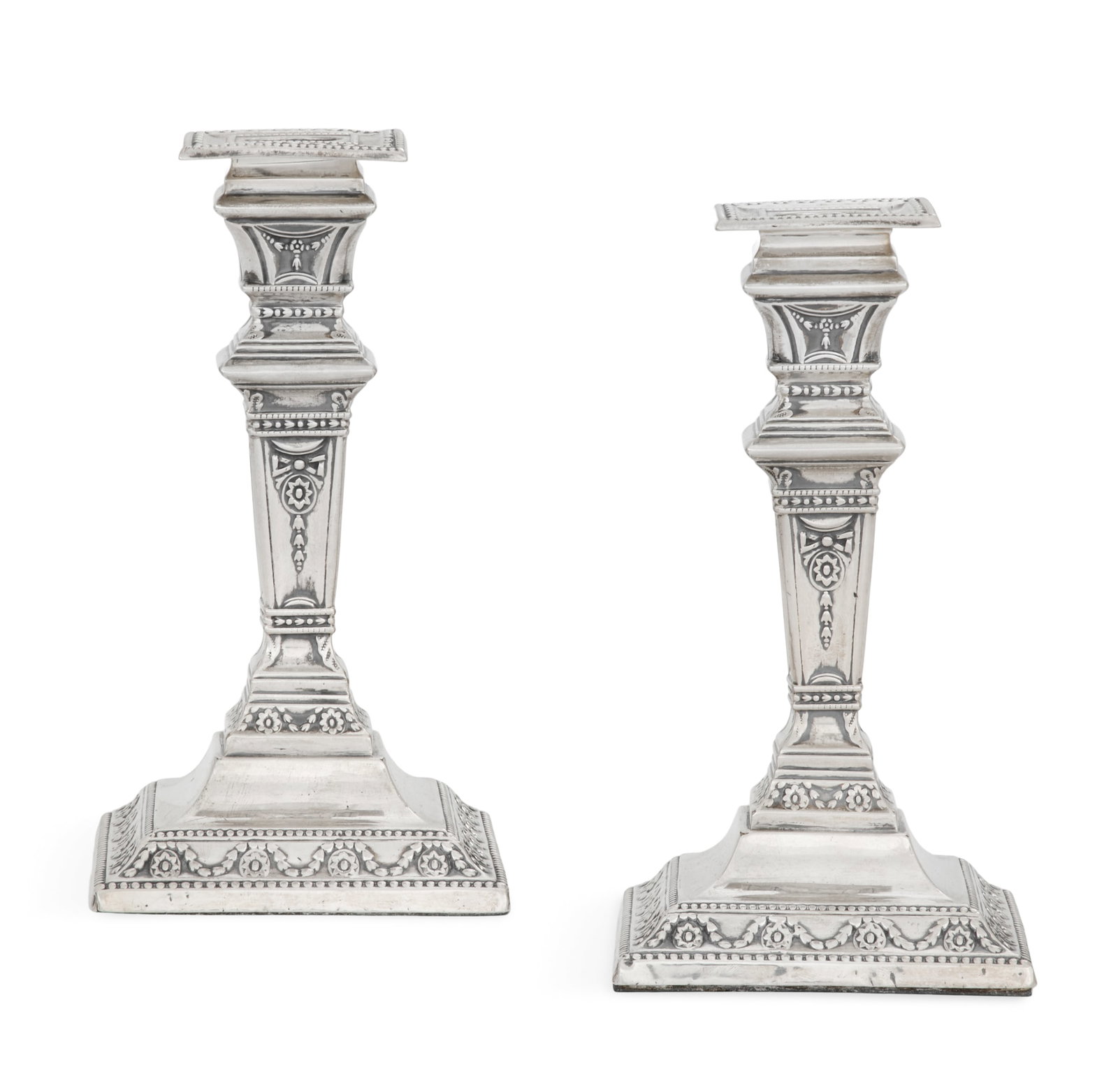 Pair of Victorian Sterling Silver Candlesticks: Pair of Victorian Sterling Silver Candlesticks hallmarked London, 1894-1895, by Charles Stuart Harris, in the neoclassical taste, of square section, decorated with embossed paterae, swags and beading,