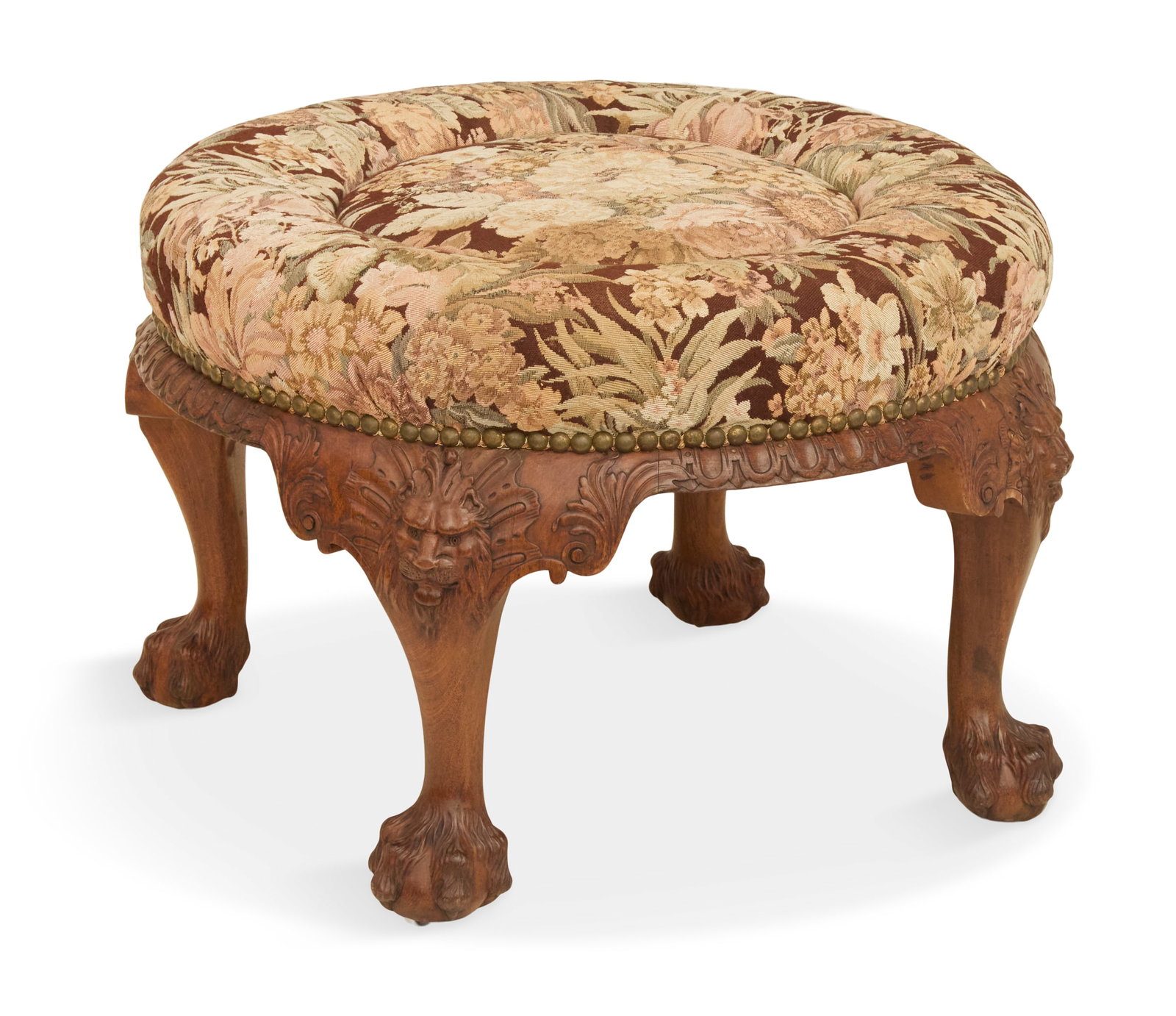 Impressive George III-Style Mahogany Ottoman: Impressive George III-Style Mahogany Ottoman 19th century, of circular form with a padded seat over a gadroon-carved frame, with four cabriole legs, each with lion's masques and ending in carved