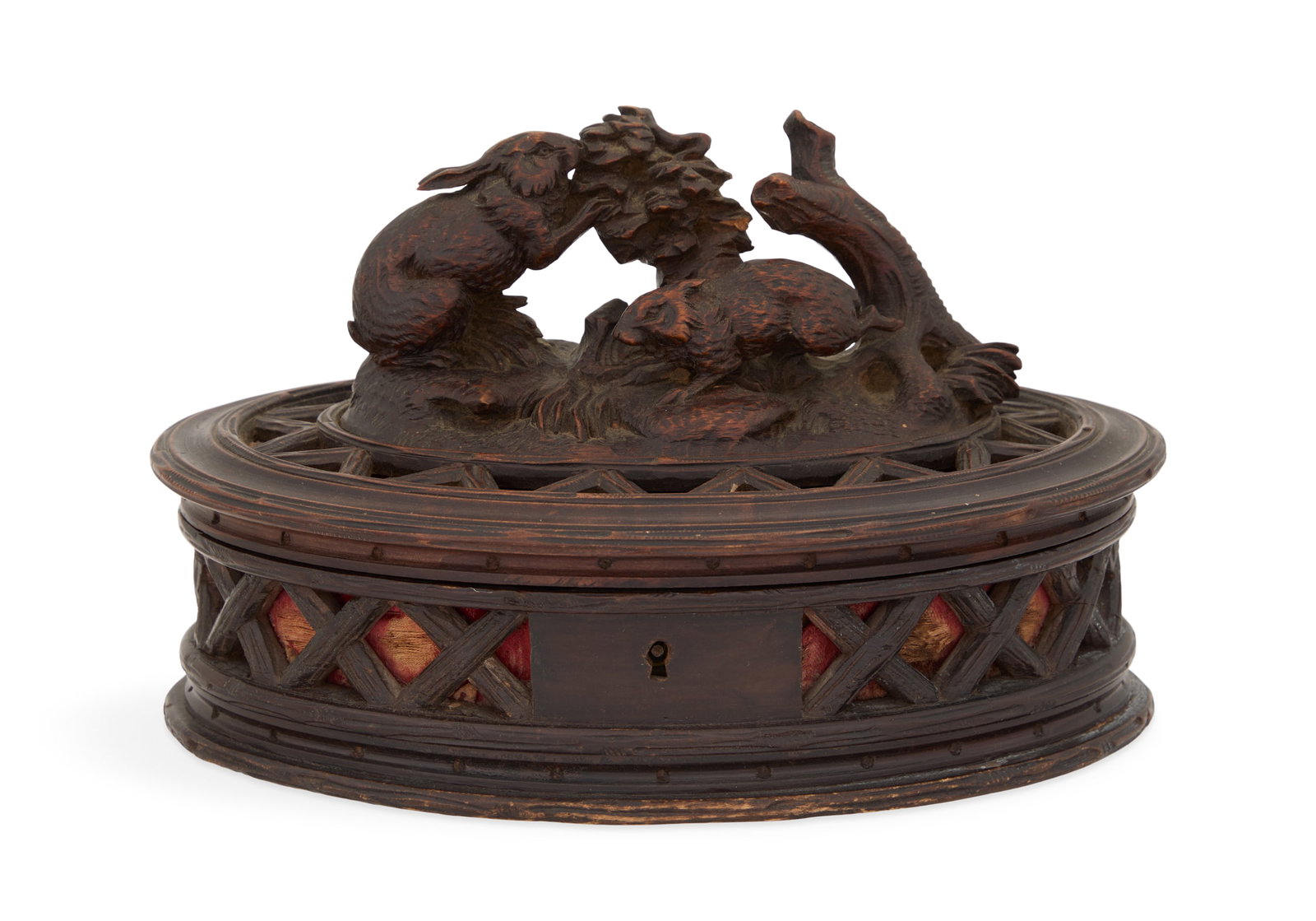 Swiss Black Forest Carved Lindenwood Jewel Casket: Swiss Black Forest Carved Lindenwood Jewel Casket fourth quarter 19th century, the oval box with a hinged cover with rabbits nibbling foliage, the sides with pierced latticework, the interior with an