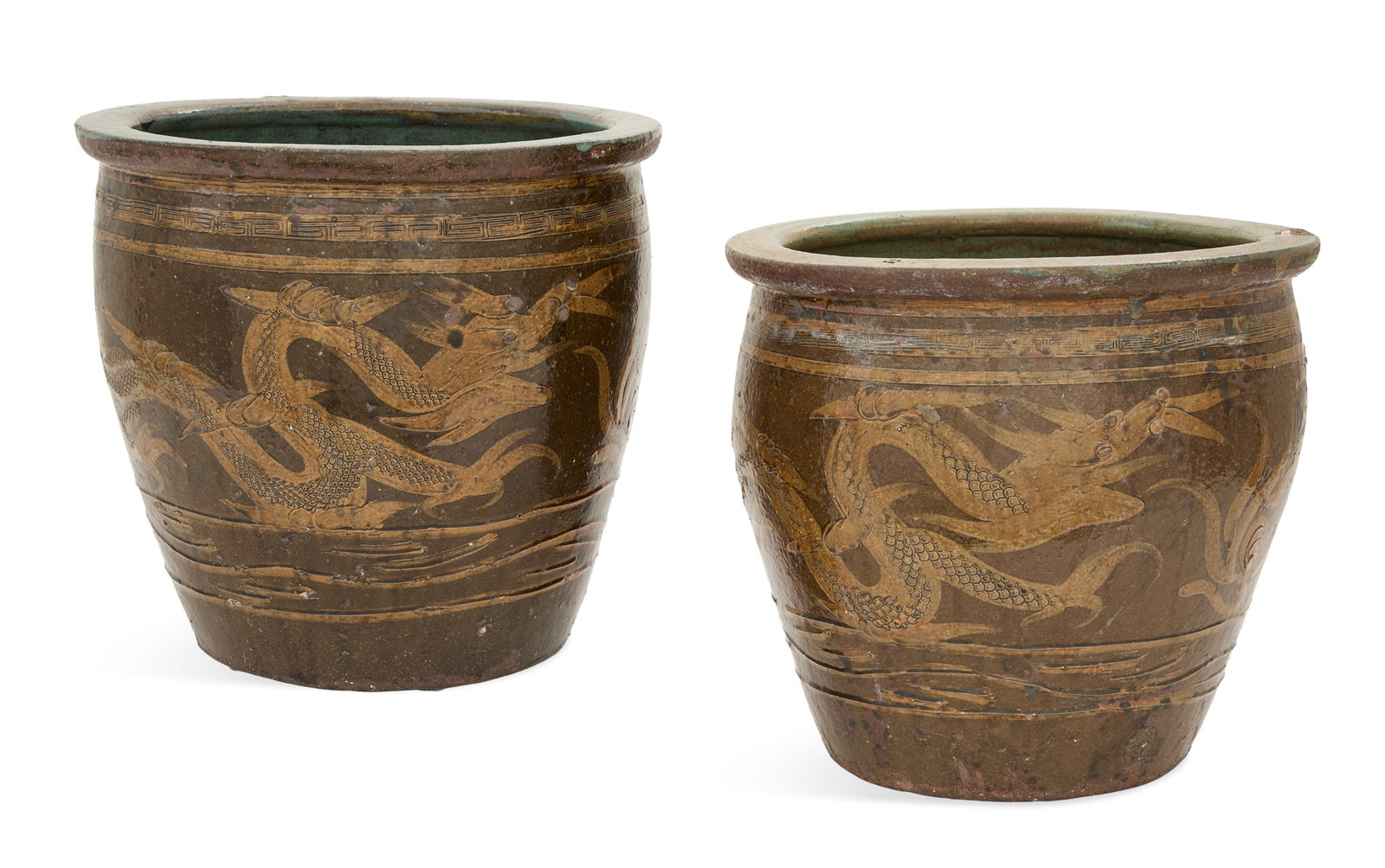 Pair of Chinese Pottery Tree Tubs: Pair of Chinese Pottery Tree Tubs ca. 1900, decorated with amber dragons on a brown ground, framed with fret borders, with blue interiors. h. 16-1/4", dia. 17-1/2" Provenance: The collection of
