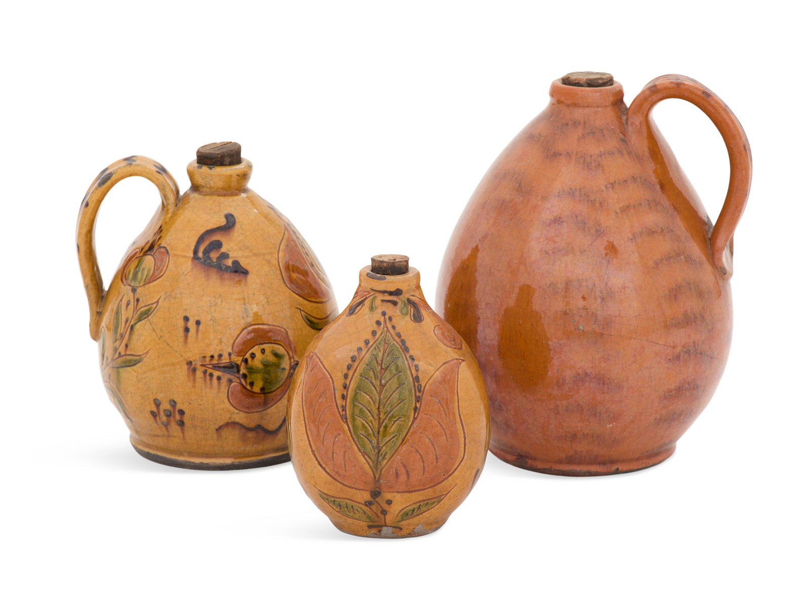 Collection of Three Greg Shooner Redware Jugs: Collection of Three Greg Shooner Redware Jugs 20th century, two with sgraffito decoration and slipware, the largest with manganese iron oxide feathering, each signed on bottom. h. 5-1/4" to 7-3/4",