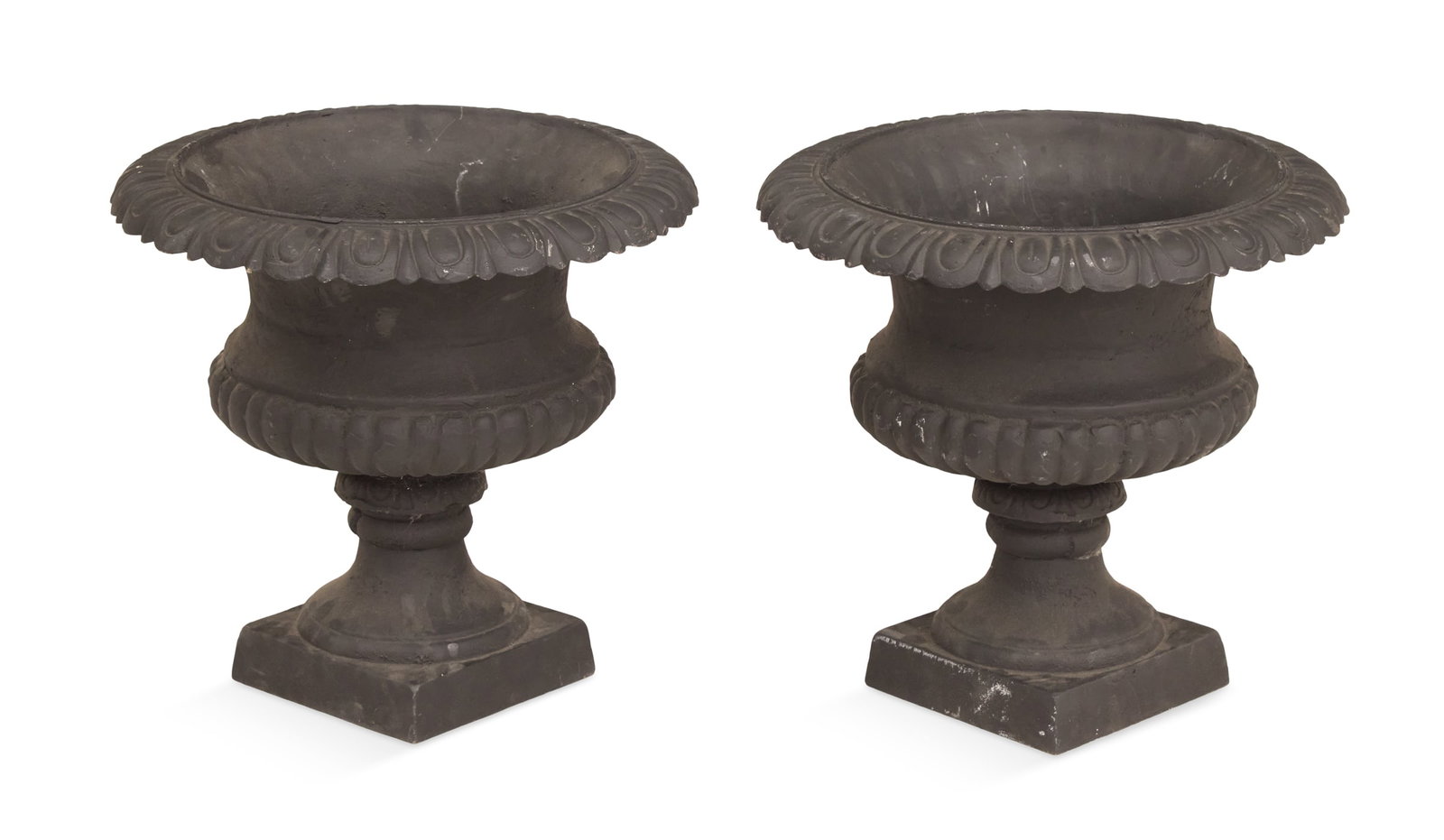 Pair of Black Cast-Iron Neoclassical Garden Urns: Pair of Black Cast-Iron Neoclassical Garden Urns the egg-and-dart rims over the reeded bodies, raised on tapered bases with square plinths. h. 18-1/2", dia. 17"