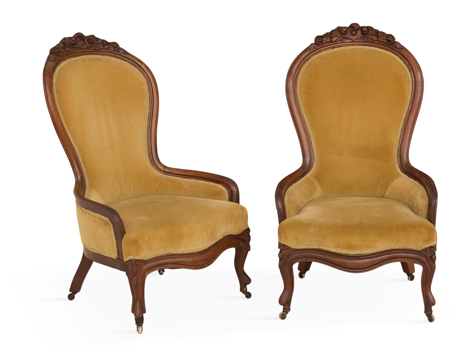 Pair of American Rococo Revival Bustle Chairs: Pair of American Rococo Revival Walnut Bustle Chairs 19th century, the smooth molded frames with foliate-carved crests and closed arms, raised on short cabriole legs. h. 41", seat h. 15", w. 24", d. 2