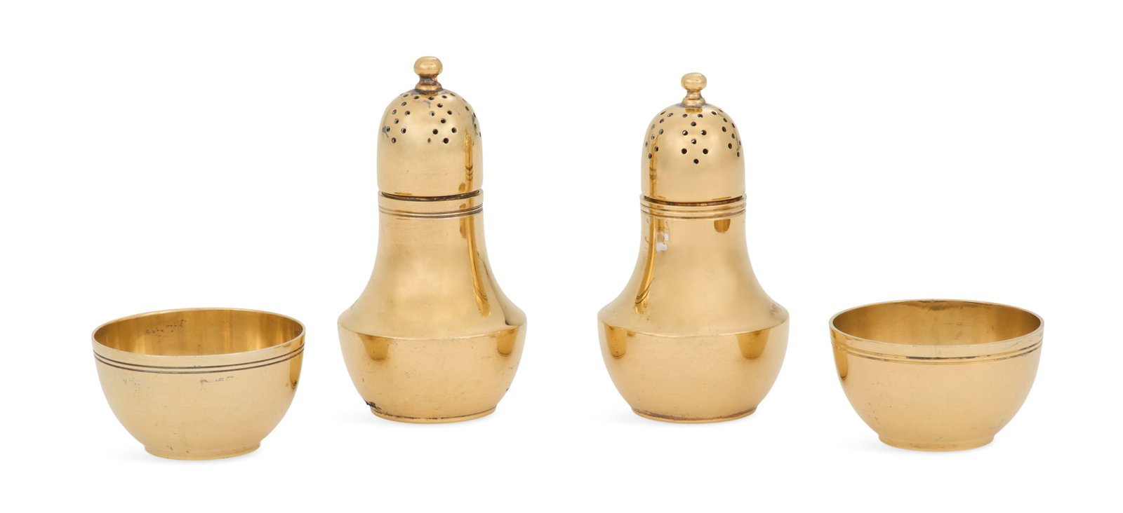 Tiffany & Co. Silver-Gilt Salt and Pepper Set: Tiffany & Co. Sterling Silver-Gilt Salt and Pepper Set the pattern introduced in 1924, this set third quarter 20th century, including a pair of pepper casters and a pair of salt cellars, the former