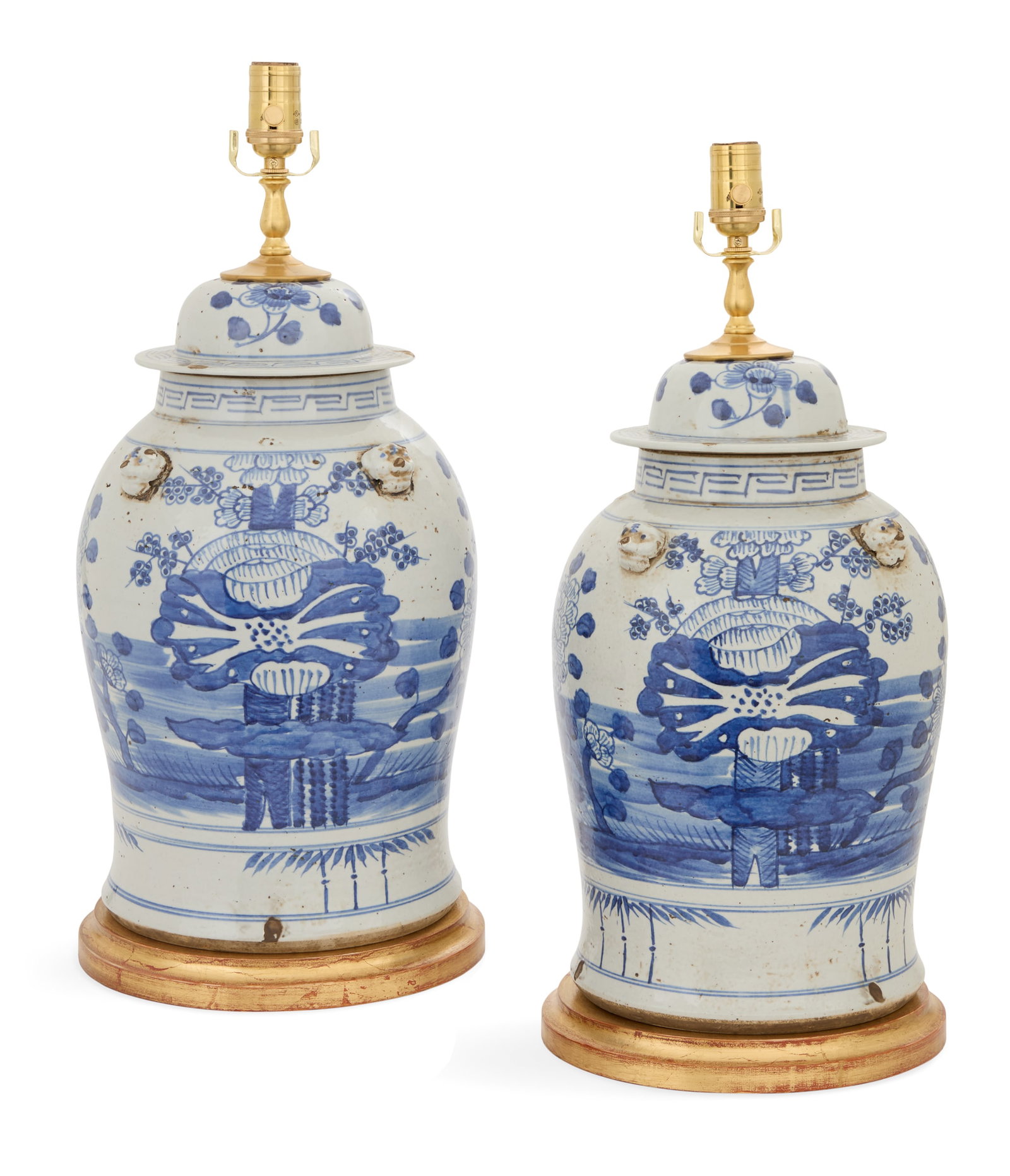 Pair of Chinese Porcelain Ginger Jar Lamps: Pair of Chinese Porcelain Ginger Jar Lamps contemporary, decorated with flowers and trees, the shoulders mounted with foo dog masques, on giltwood bases. h. 24-3/4", dia. 8-1/4"