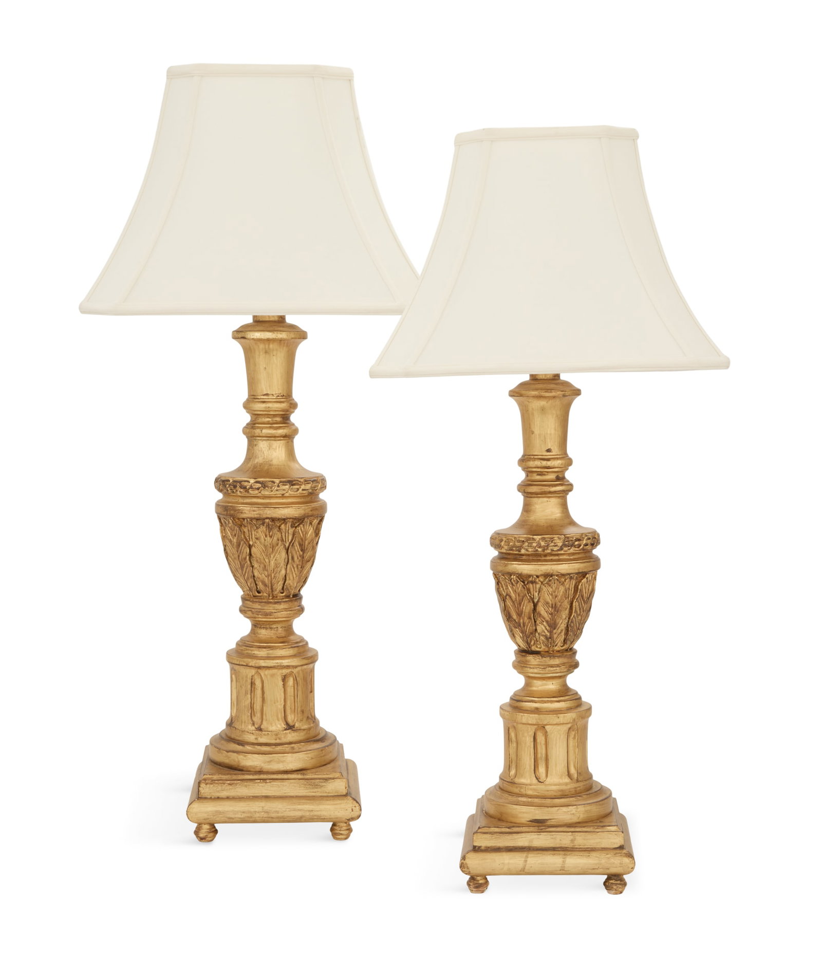Pair of Hollywood Regency Giltwood Table Lamps: Pair of Hollywood Regency Giltwood Table Lamps 20th century, the acanthus-carved urn-form standards mounted on fluted column-form bases, raised on turned feet and fitted with lampshades. h. 35", w. 16