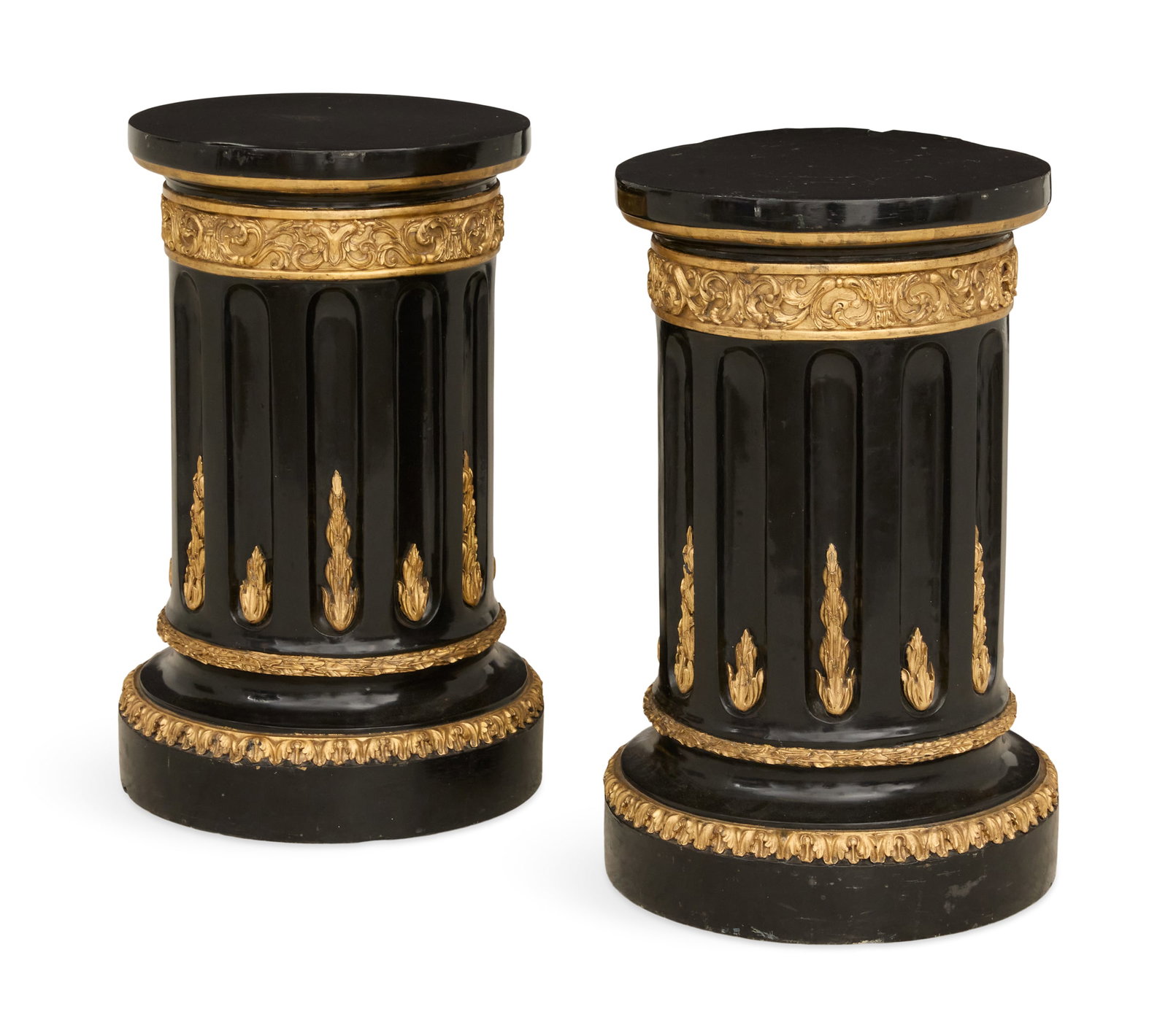 Pair of Monumental Ebonized and Gilt Pedestals: Pair of Monumental Ebonized and Gilt Wooden Pedestals each of columnar form with a circular top over a conforming circular fluted shaft, headed by a gilt scrolling foliate band and resting on a waiste